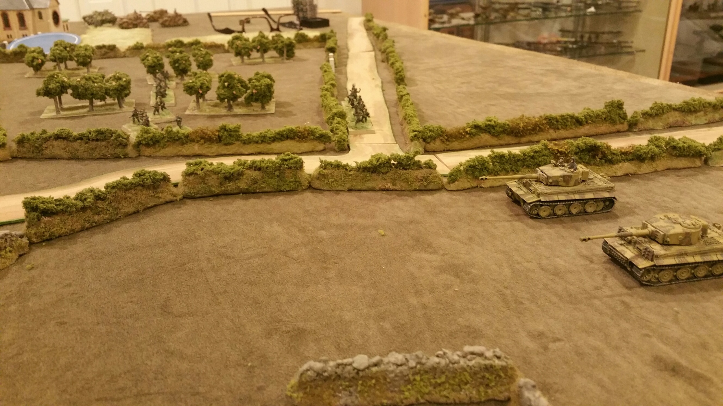   The Germans enter from the east. Tigers on their left, supported by dismounted grenadiers in the center and the Pz IVs and more mounted infantry on the right trying to make an end around the church into town.  