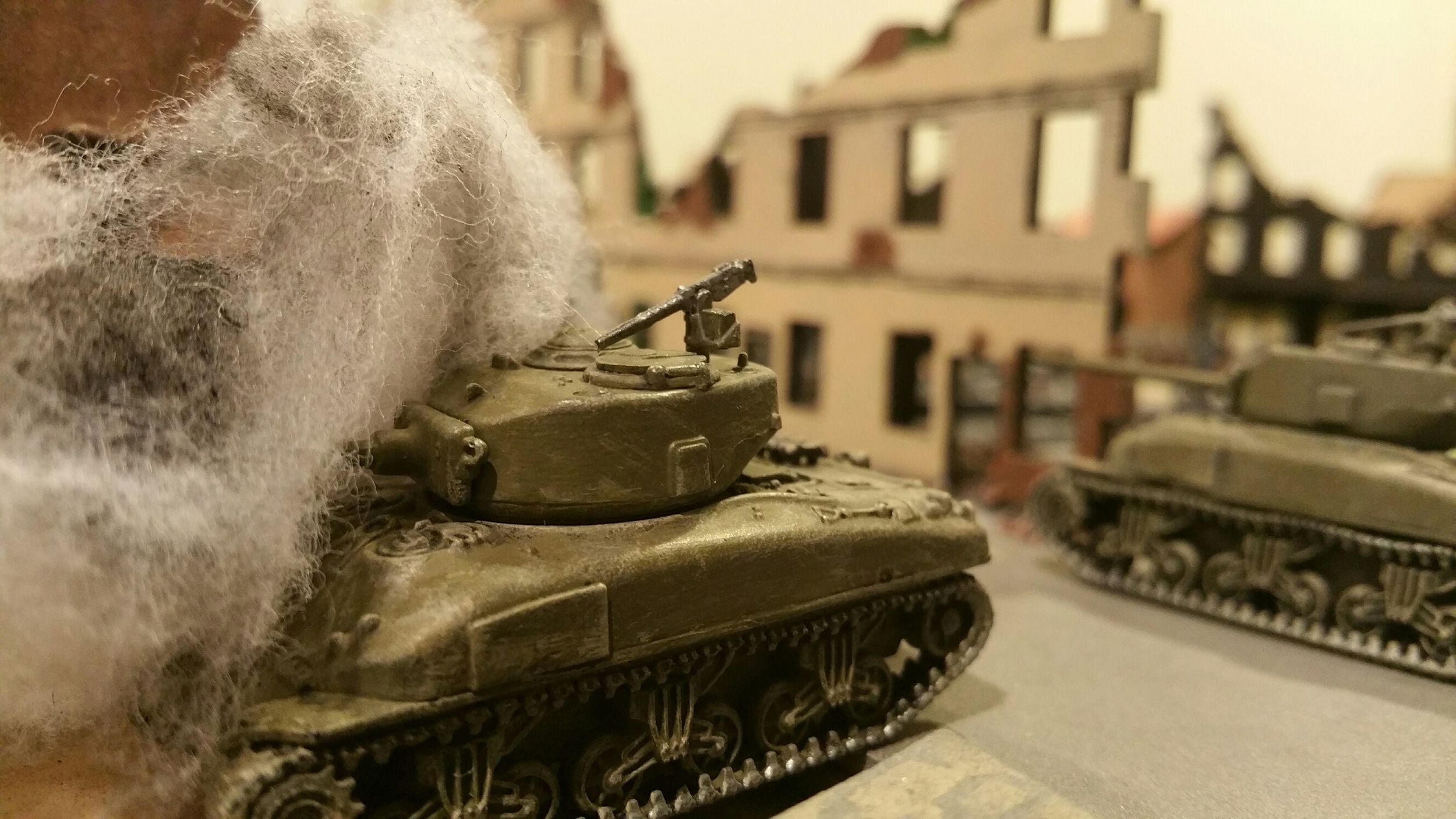   Big gun Sherman burns in the center of town after dueling with the Pz IVs.  