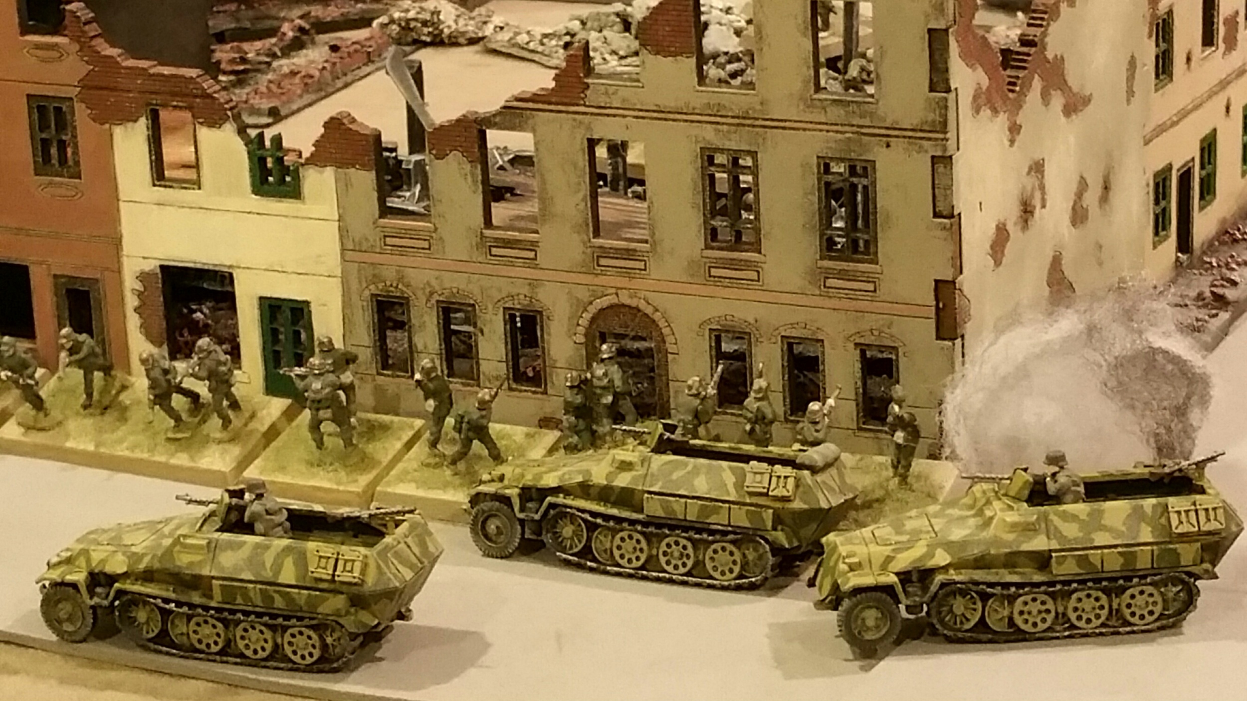   The German infantry pushes in the center. After a bloody repulse of one platoon in close combat, 2 others push into town. Armored Panzer grenadiers disembark and begin to push the remaining G.I.s in town.  