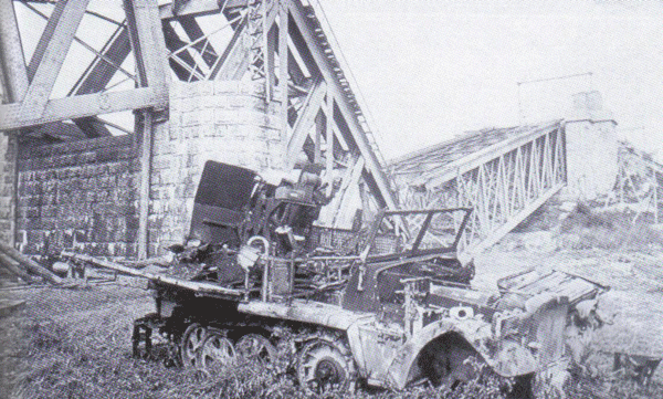 One of the SP Guns engaged by Baskeyfield was this SdKfz 10/4 half-track mounting a 2cm gun beside the northern pillar of the blown railway bridge (see map above) about 900 yards from his position on the road junction pictured here by Dutchman Dick Renes in 1945.