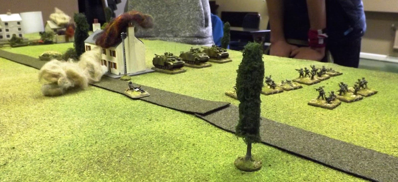 The SS men were naturally cautious and took time to "brass up" likely enemy positions on their approach. Note the mortar FOO on the road searching out likely enemy positions.