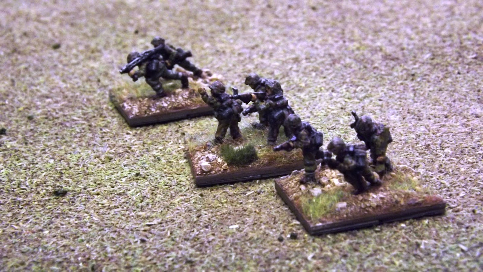 An SS Infantry Zug advances across open ground devoid of much cover