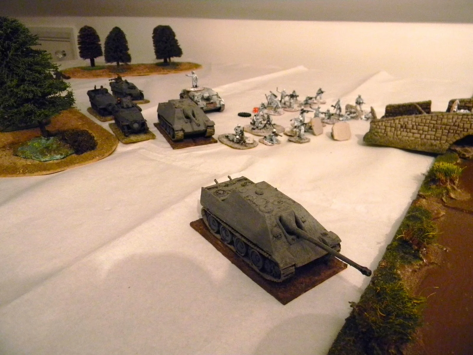   By now, one JagdPanzer has reached the river line as the others with the half tracks follow  