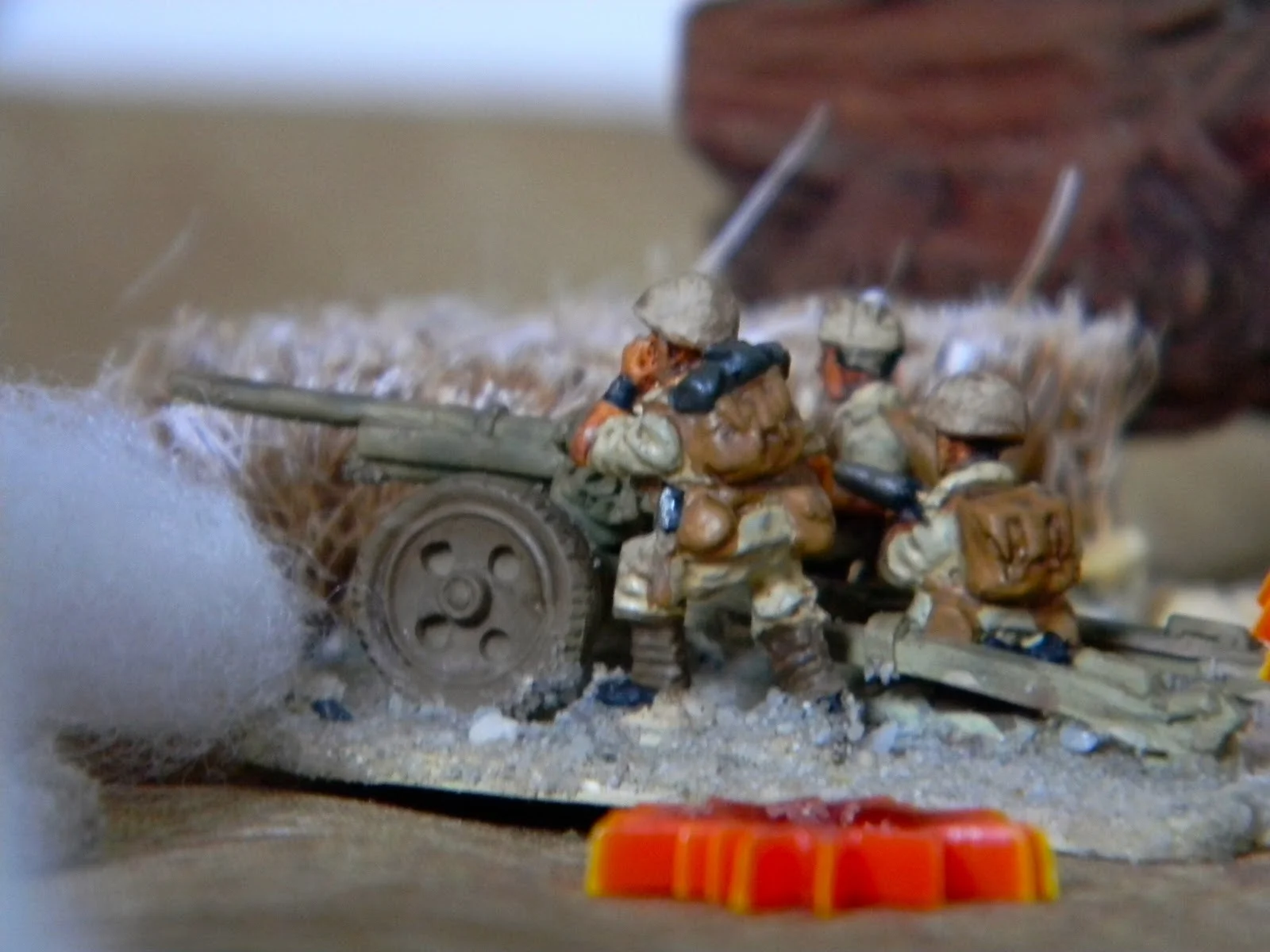   The Italian gunners keep up their fire on the British tanks  