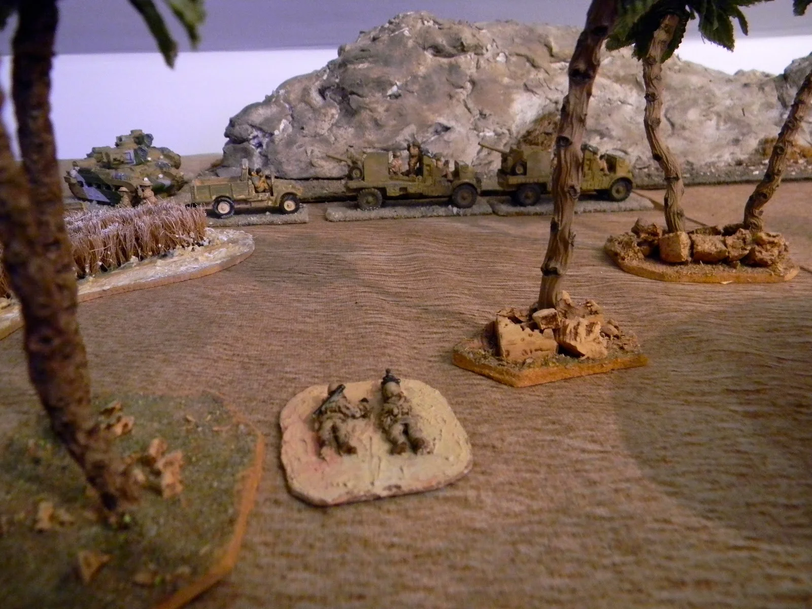   Trying to support the Valentine charge, a battery of AT guns in Portees get caught in the open by another Italian AT team, side on.  