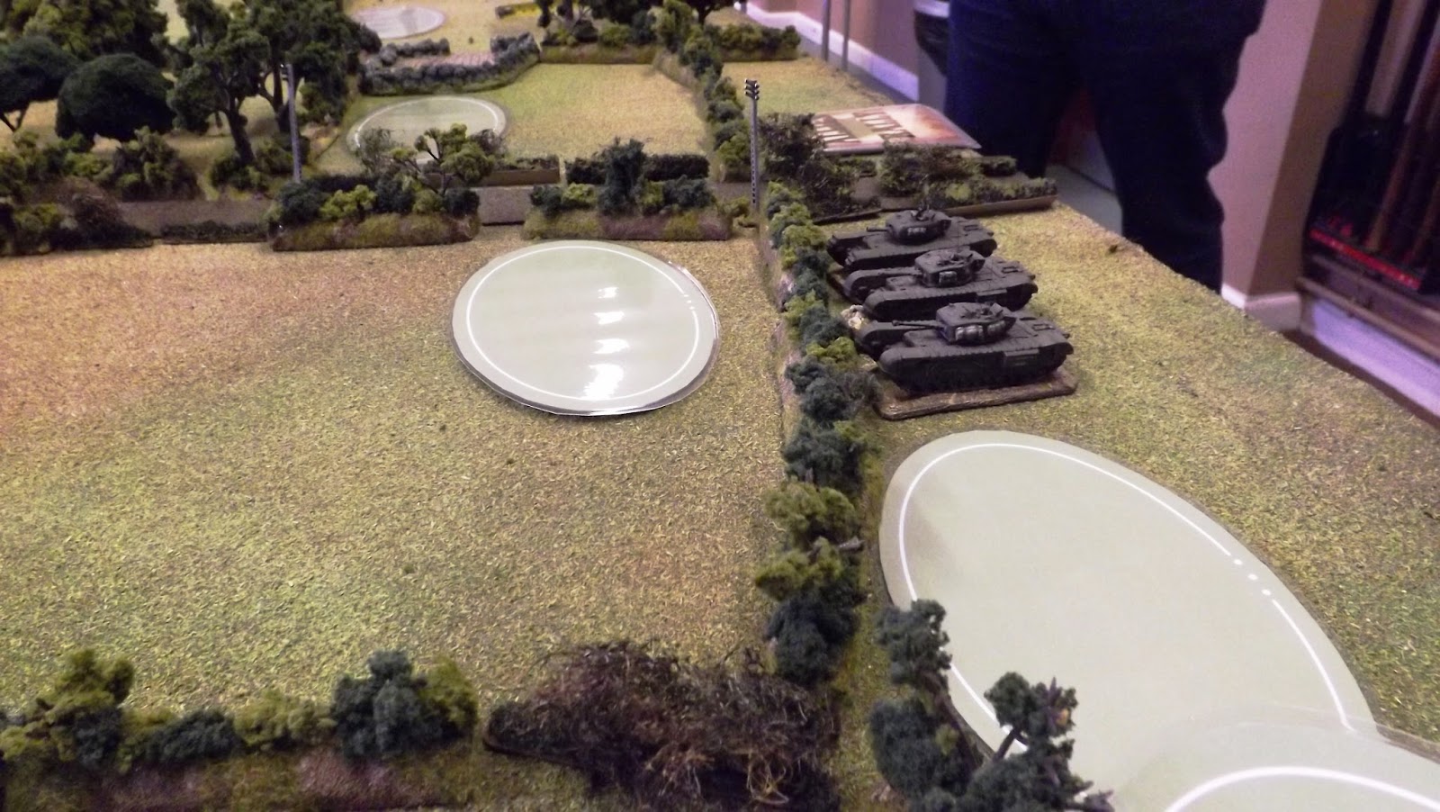 Scots Guards Churchill tanks on over-watch as their comrades move out into the neighbouring fields