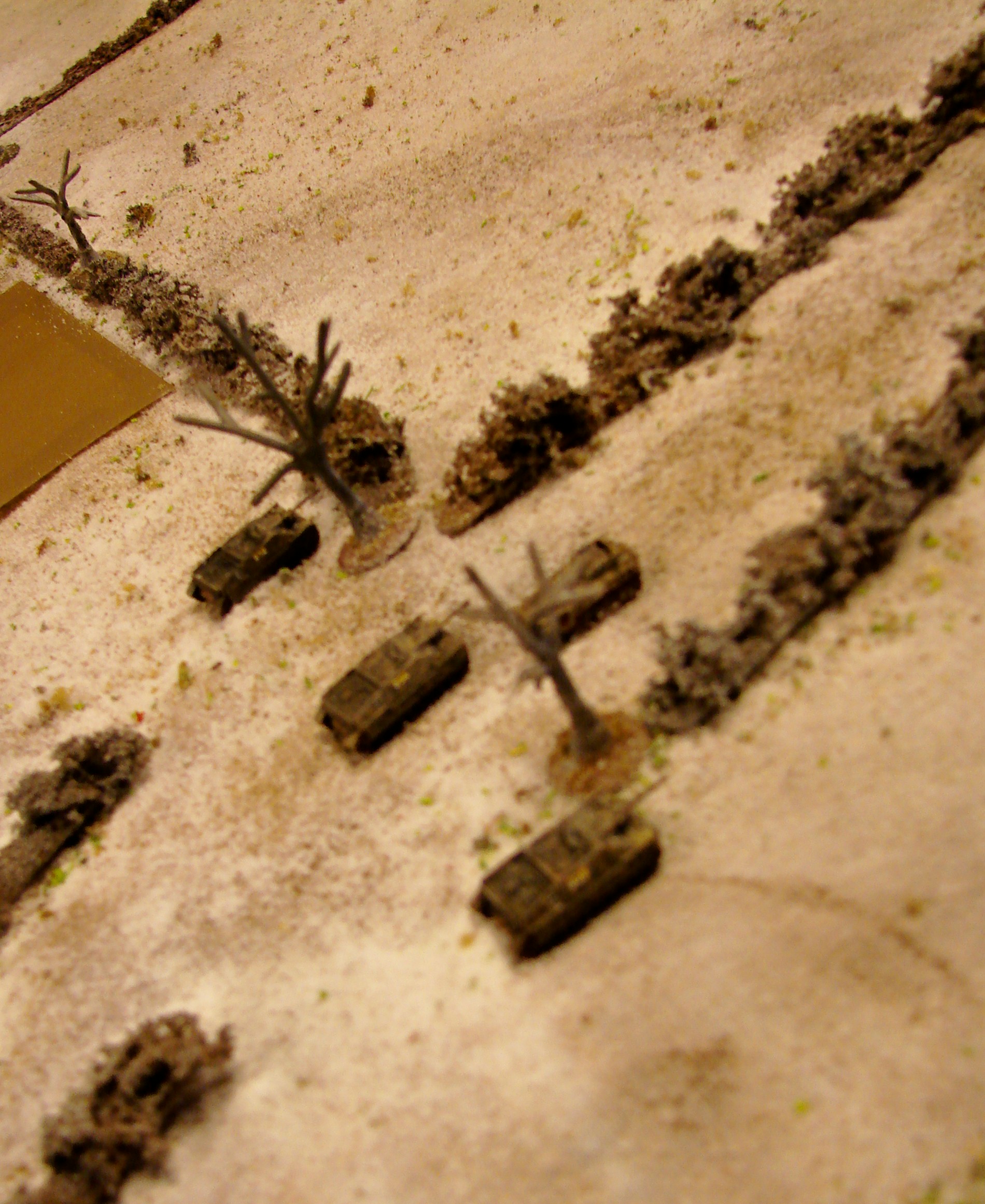 Panzerjaegers deployed The remaining halftrack makes it to its comrades near the bridge. Too bad about the fuzzy picture. The cards in the pictures are all blinds. When spotted or activate they are placed in the discard stack. Another nice thing about gaming in 6mm. The cards are the perfect size for blinds.