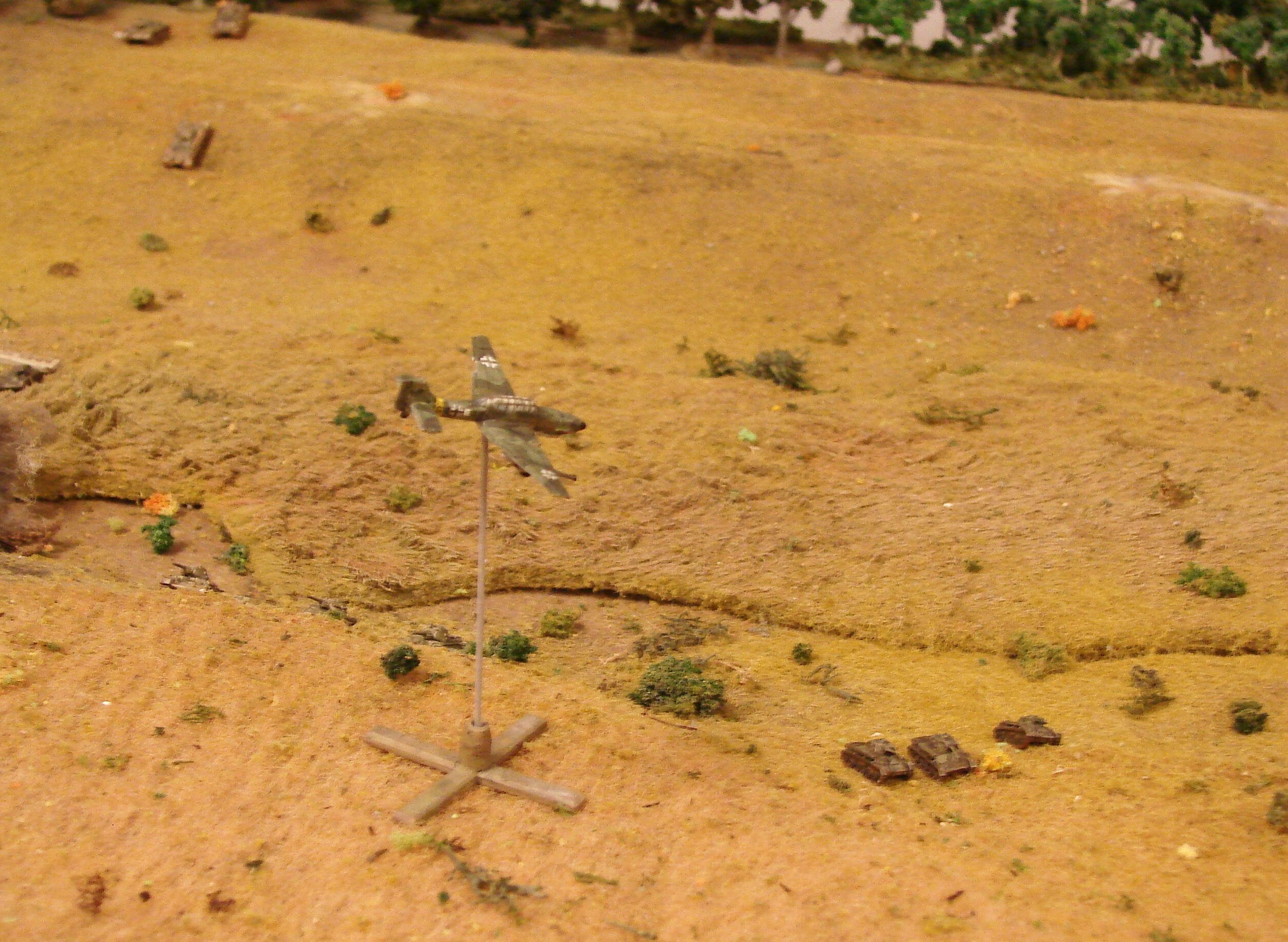 Stuka attack Despite the air support card coming up quite often, the Luftwaffe was not on their game today. The first few turns there was no movement by the Russians, so the Stukas needed an '8' or higher (2D6) to spot. No luck then. When they did see something, I then rolled to find out what was coming in. On a D10, 1-4 meant a JU87D, 5-8 was a JU87G, 9 was two JU87Ds and a 10 was two JU87Gs. The two times when a Stuka did show up, it was one JU87G and both times they totally missed their target. No Hans Rudel there. Notice the T34 crepping up the slope to the left. They can't go hull down though: not their doctrine and the gun can't depress enough.