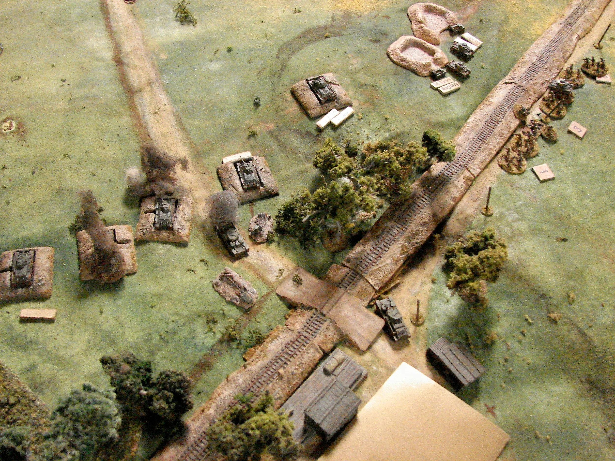 Action at the RR crossing A couple of the T34s are already smoking. My surviving T28 made a reluctant return to the front to take a shot or two at the advancing panzers.