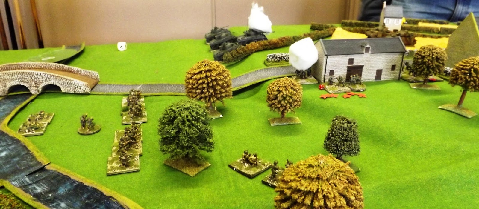 As the armour on the left 'bumps' enemy tanks the Canadian infantry moves in against the buildings under the cover of 2" mortar smoke rounds and plenty of small arms fire (note the red shock markers)