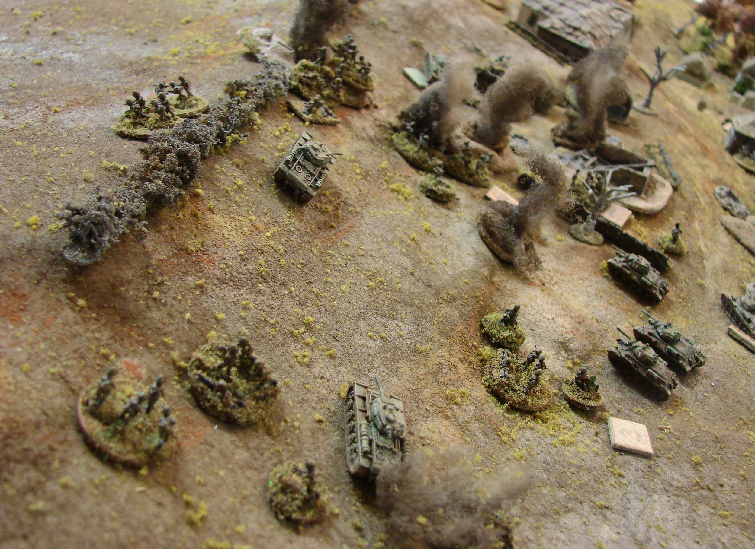 Russians up to the ridge top Having cleared out the defenders form this portion of the village, the Soviets move up to the top of the dividing ridge and the windbreak scrub line to peer at what's over on the other side. Meanwhile the firefight with the German MMG and supporting survivors goes in the Russian favor. The armor however can't seem to get a card and just waits on the out skirts of the village. The AA halftrack decided that it needed to pull back in the face of the T34s.