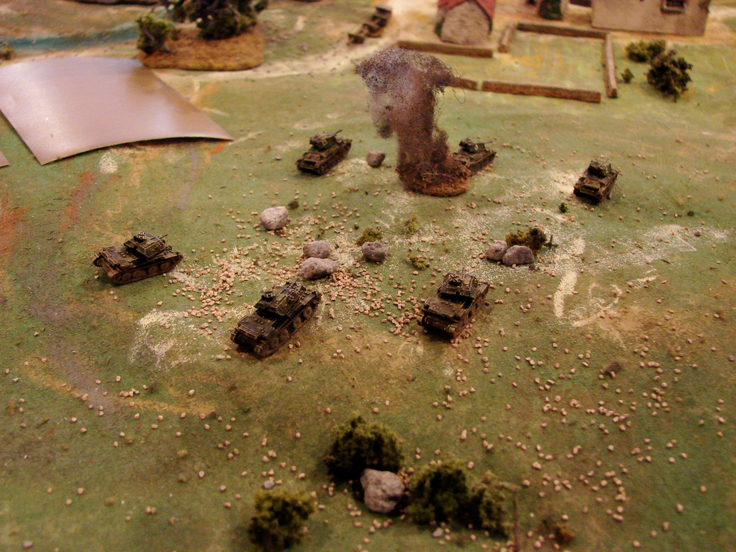 A13s and A10s Two of the A10s are out of action at this point. The A13s begin to engage the panzers on the ridge and a few of the panzers in the village that they can see. The HQ troop is on the road outside of the village. GHQ models in BEF camo. They did repaint the tanks green that went to Greece...so close enough. The British commander: Paint job or not, these were "tanks" only because they had treads...the paper-thin armor didn't help them much.