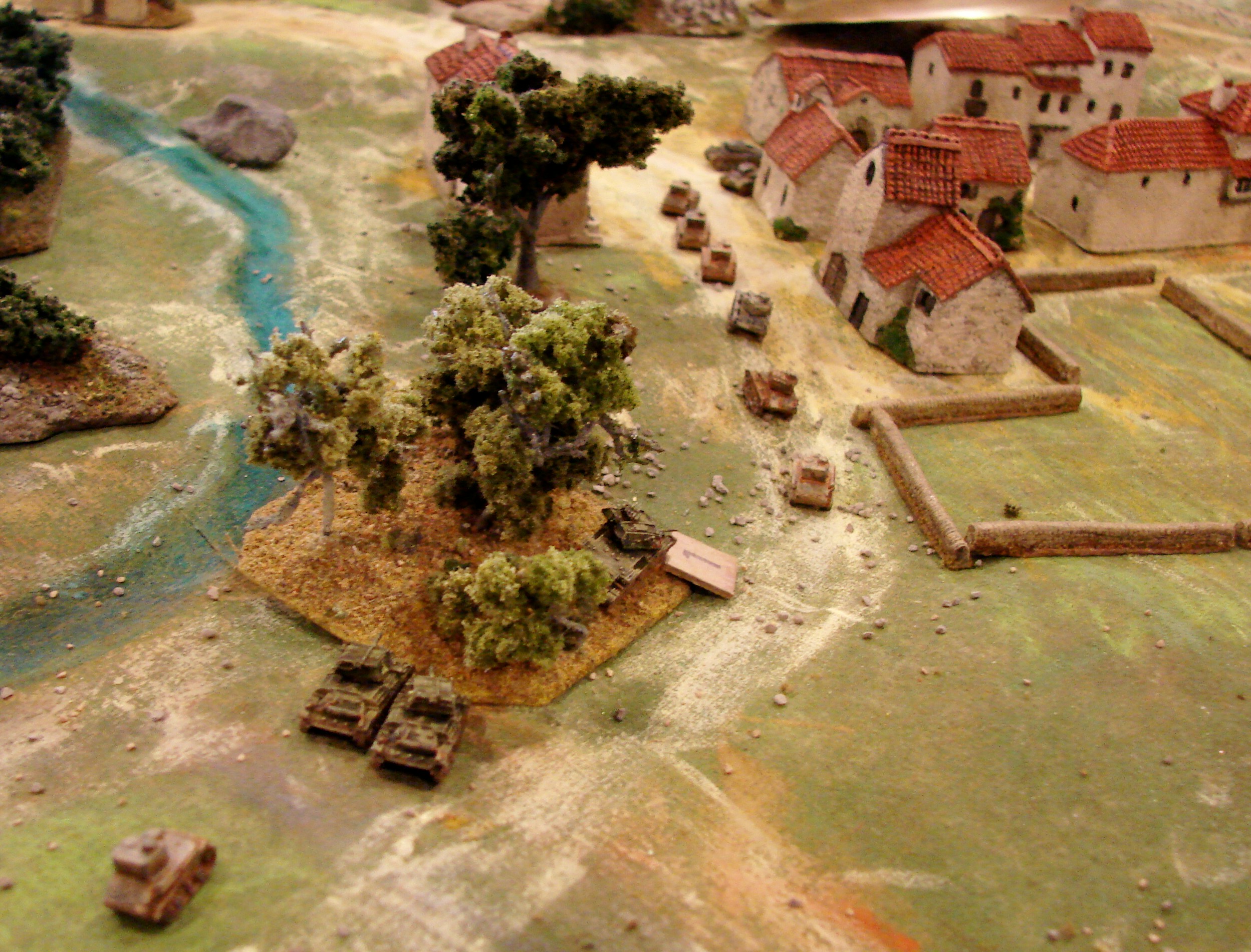 Sending in the little guys The HQ troop pulls to the side and lets the two troops of MkVICs charge into Mavropiye to challenge the light panzers. A platoon of grenadiers has also moved into the village and is occupying the row of houses along the back of the street.