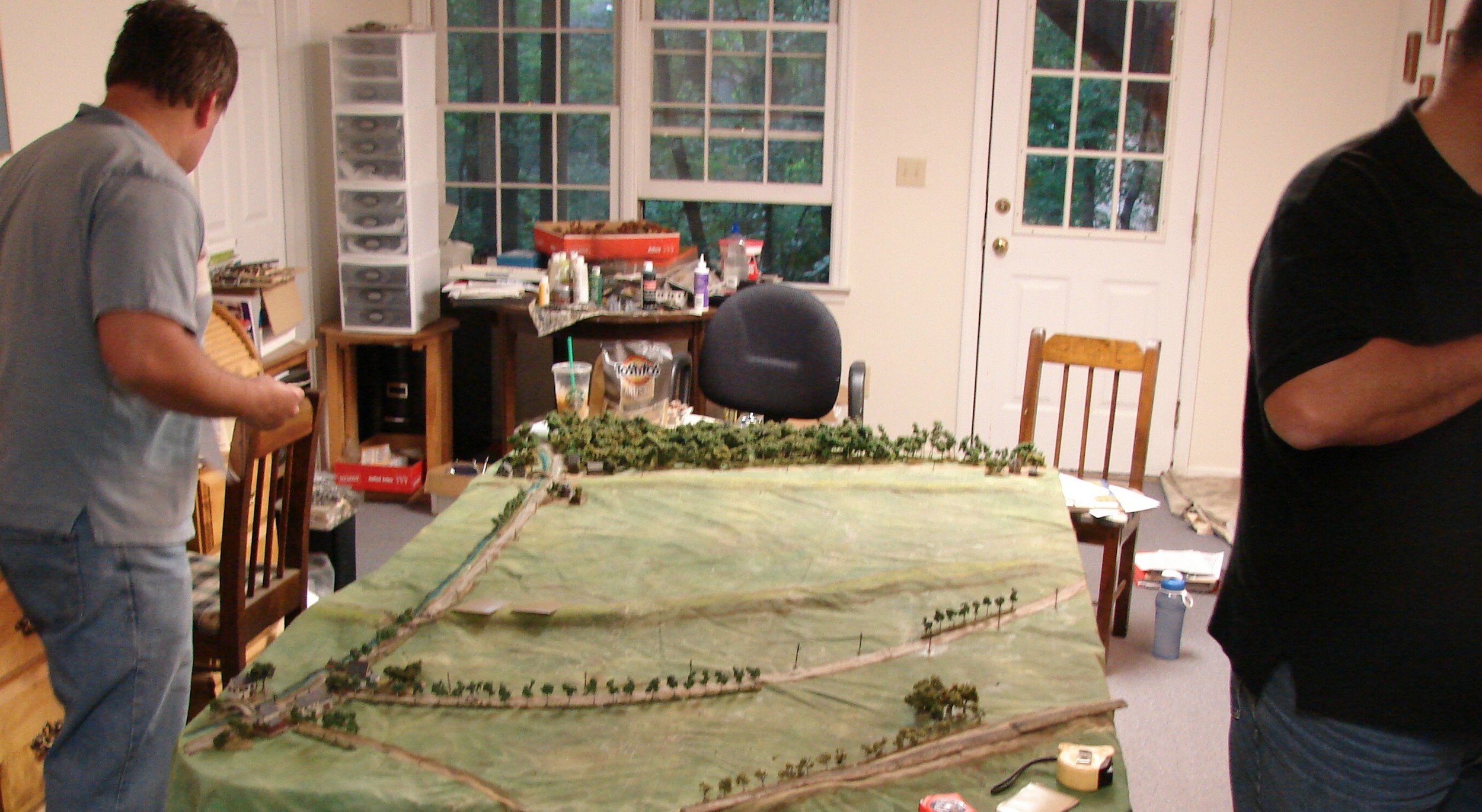 German players getting their units assembled Dennis decides on the deployment of his static troops. He didn't have much to work with but could certainly stymie the Soviet advance through a couple of routes. He started with one platoon of grenadiers, 2 MMGs, 2 PaK 40s (with RSO tractors) and 2 Big Men. Brian meanwhile with the 2 SS recce unit has a light mobile force with some decent firepower. He has 2 sections of 2 Sdkfz 250/9s, 2 Sdkfz 250/3s, 2 Sdkfz 234/1 a/c, 2 Sdkfz 234/4 (Pak 40s!) a/c and a HQ Sdkfz 251/3. The terrain is flat with two dikes crossing the table cutting off vehicle movement. He entered from the top right edge. There is a deep ditch running next to the hard surface road that goes up the left side of the table, so movement is very much funneled. There is also a RR in the lower right corner.