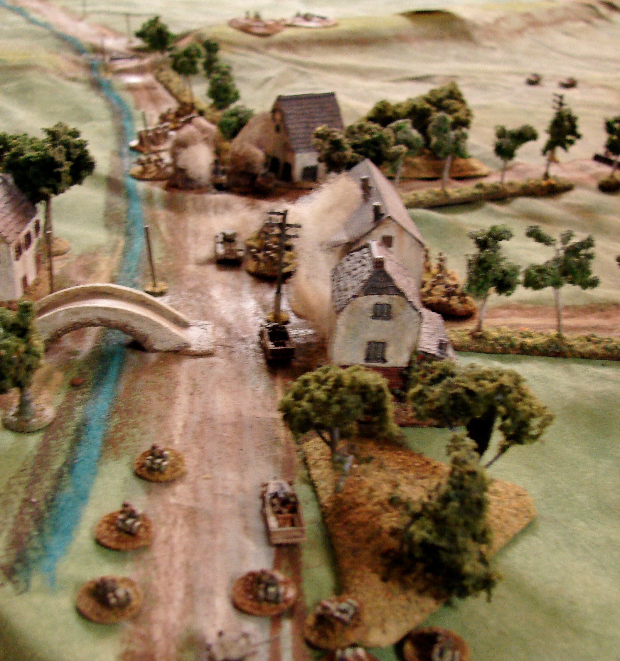 Red recon blunted The lead Valentine and an M3 are taken out by the Pak 40 and MMG on the dike. Martin ran his Gaz truck with the triple MG AA mount up and pulverized the MMG , but was promptly nailed by the Pak. Its smoking in the center of the mess up towards the block. Return fire from the other Soviet scouts is taking a toll on the weapons crews though.