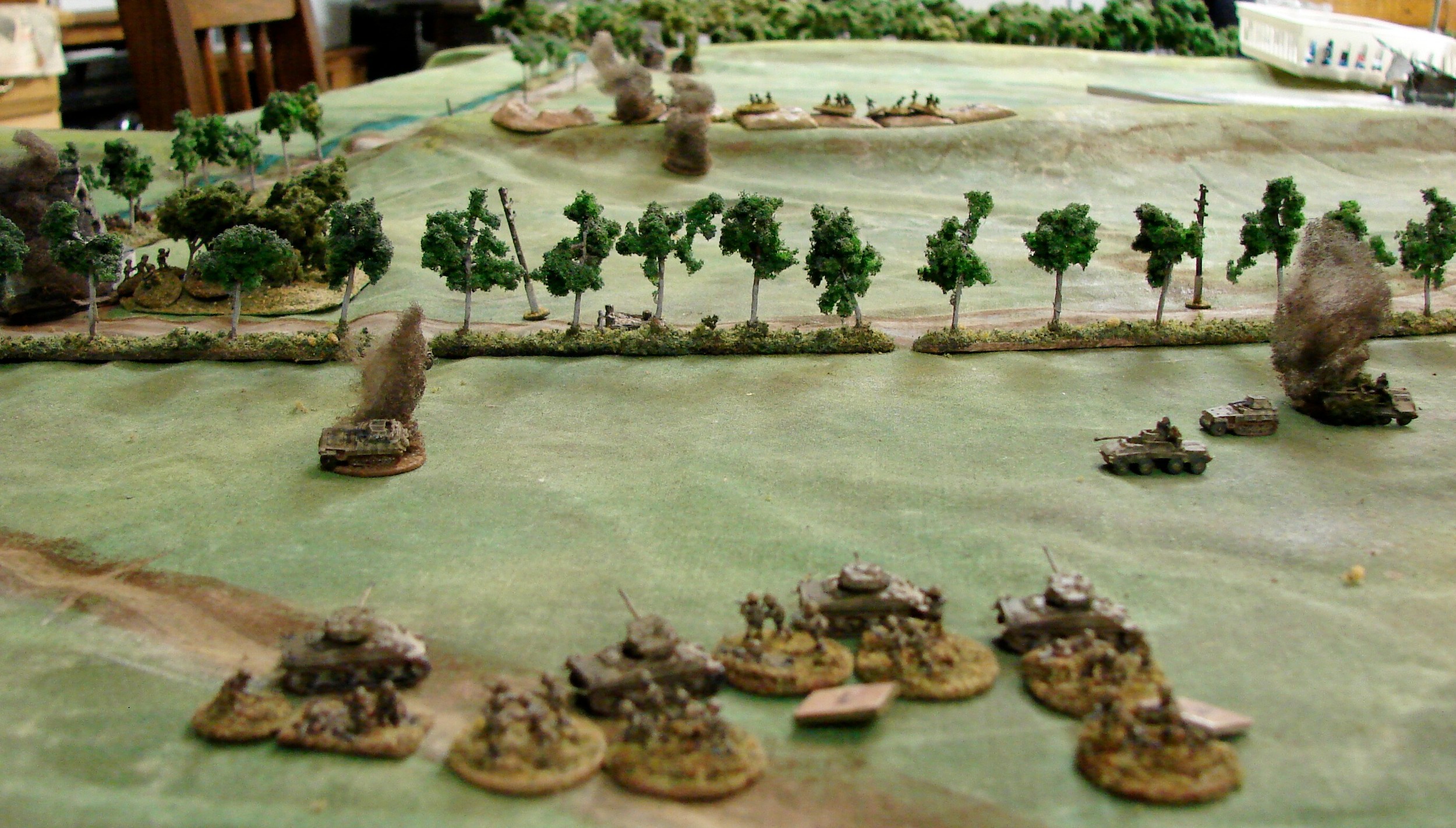 Tank riders dismount and use the tanks for to hide behind. Not much the infantry can do out here but take cover.