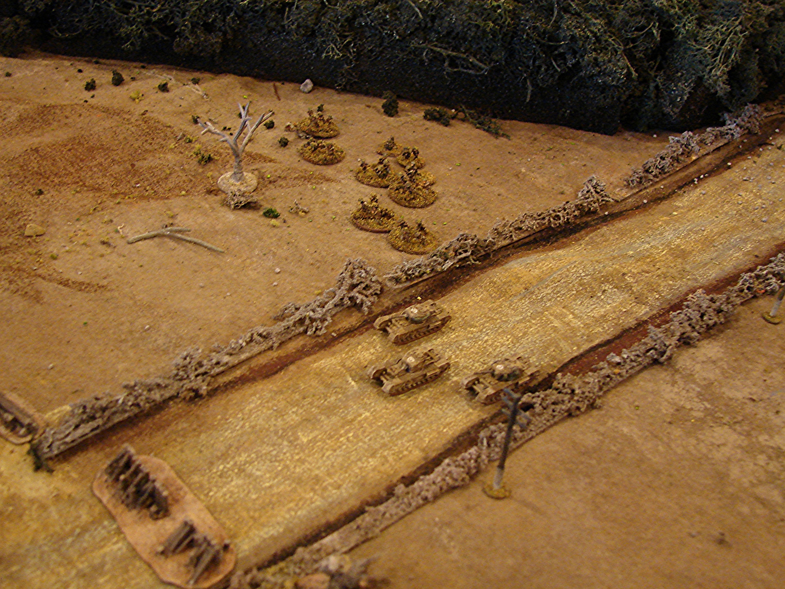 Wide road with narrow passage I really needed to make these road a bit less wide. That's what happen when you do a few 15mm games before getting back to 6mm. But the path is still not very promising for the Churchills. I told Brian that sure, he could knock those wooded post down, but they could be booby-trapped. So he opted to turn right and cross the ditch and hedge, losing a dice of movement and risking getting bogged.