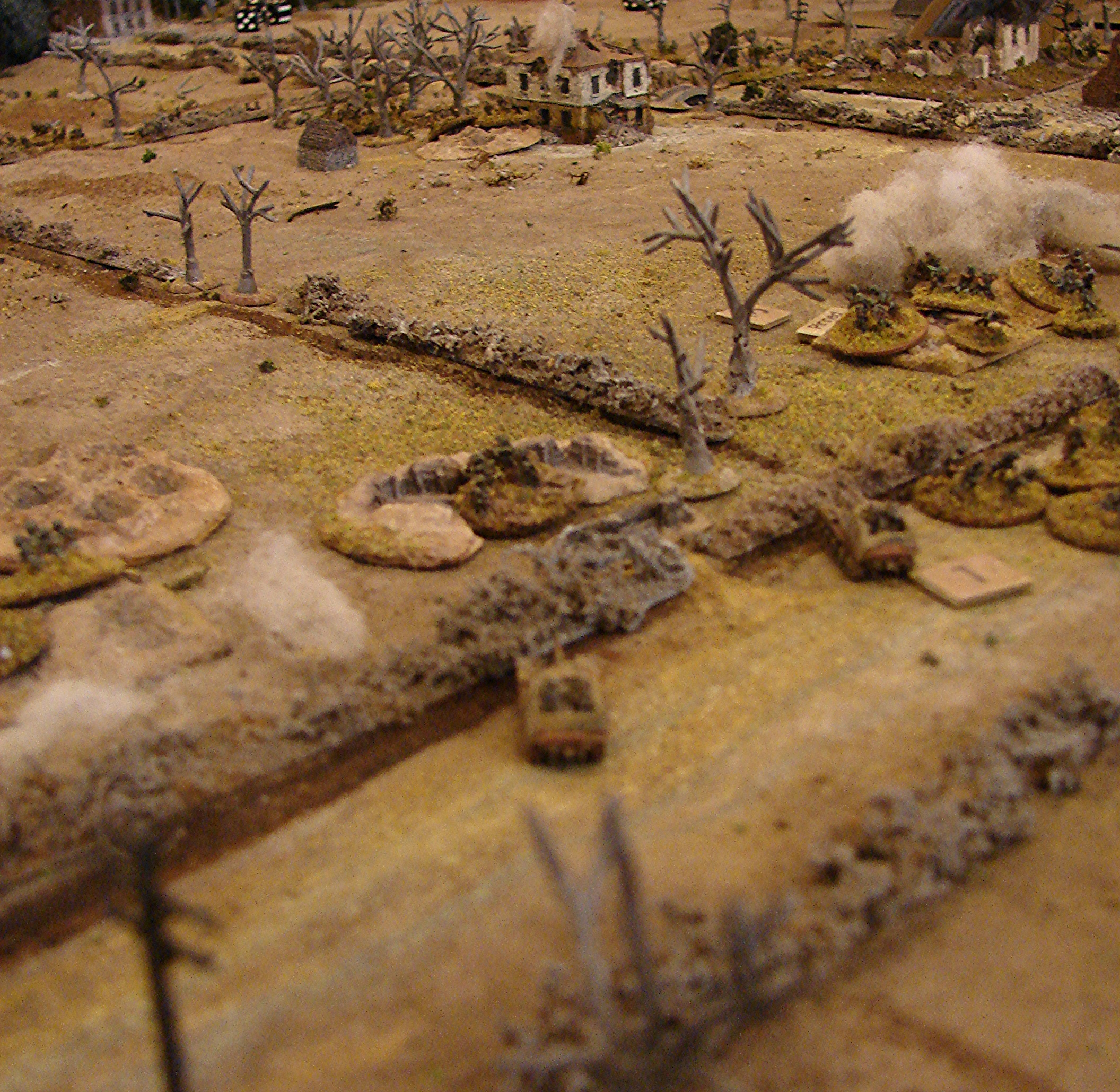 Marders deploy They spot the Churchills across the fields and try to even up the odds. The vehicles trade some iffy shots and the Marders come off the worse for it with the lead SPG getting a solid hit that knocks its gun out. The 2 inch mortars are laying down smoke on some of the dug-in Germans. And the new platoon of reinforcements is having trouble deciding if they really want to re-take the buildings at the far edge the table.