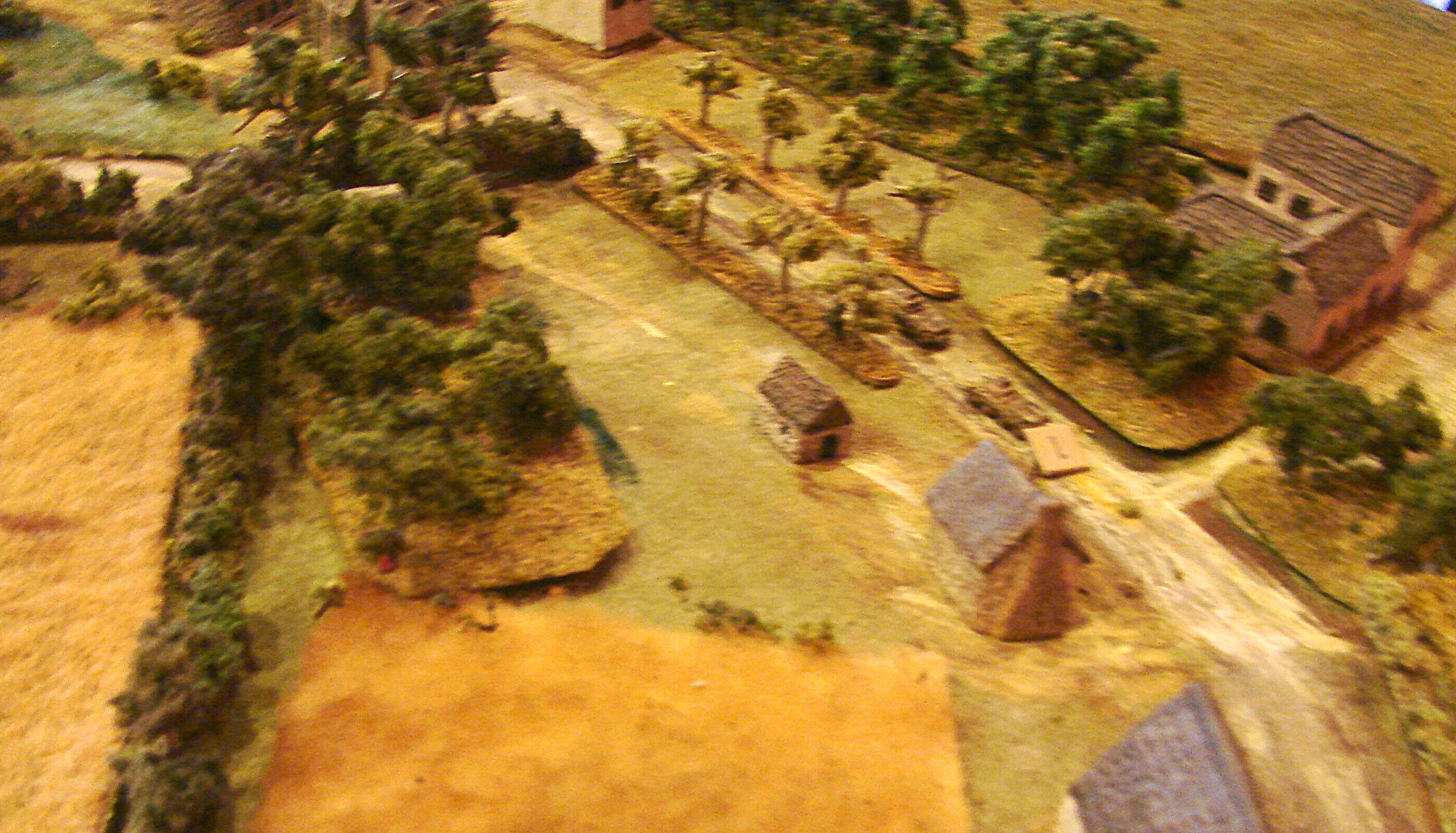 3 Zug with its Sdkfz 250/9s After getting no movement for the first several turns (the German Blind card just wouldn't come up) Tim had a nice open road. The zug of 250/9 halftracks gets to move at top speed down the road towards the beach. Another fuzzy picture. The lighting at Gigabites is really terrible. I can't even tell if the field is in focus when I (or others) take these snaps.