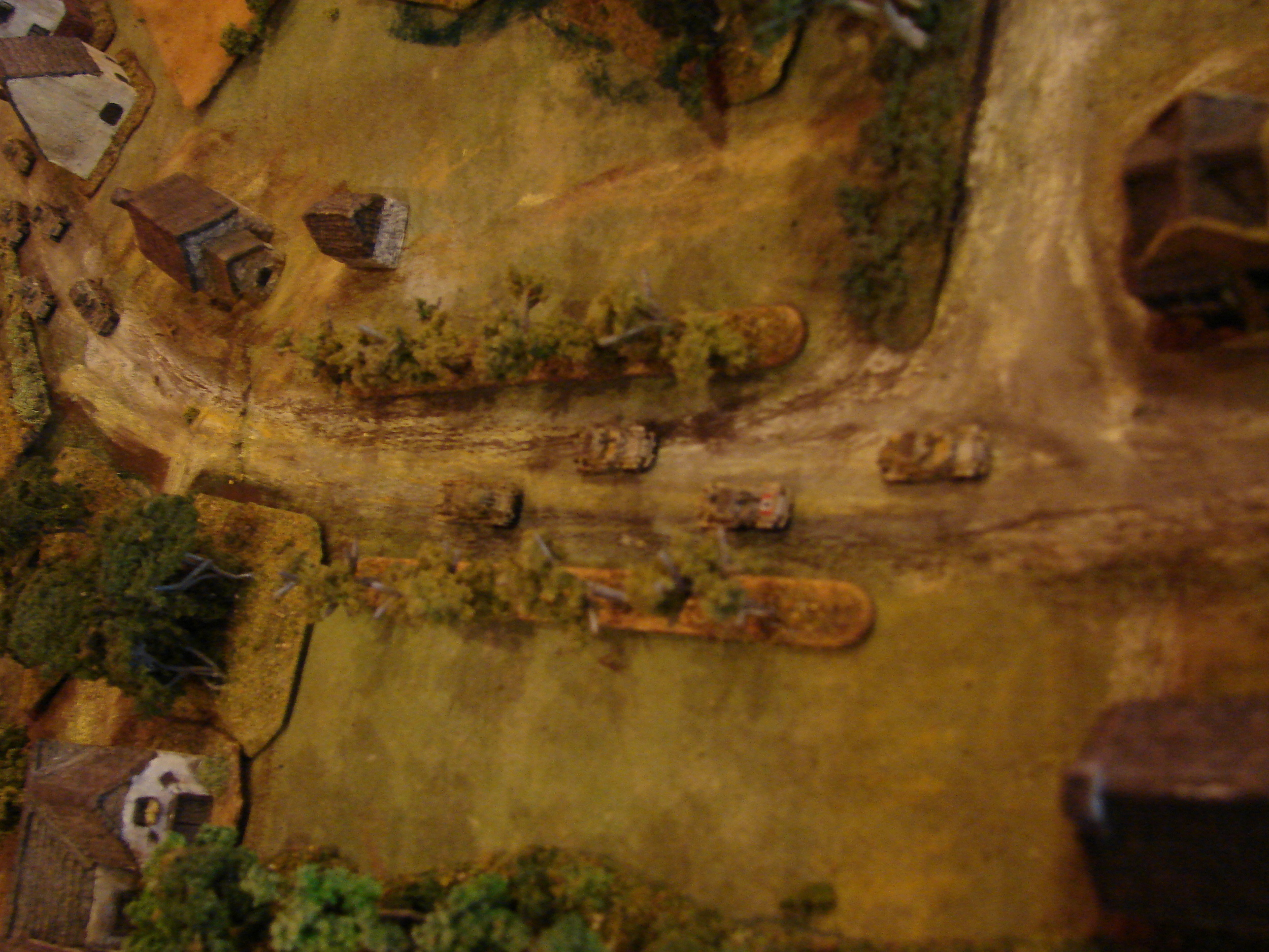 The light armored cars The group of Sdkfz 222s followed the heavies down the main road but went straight instead of turning left. The burning Humber LRC is in front of them.