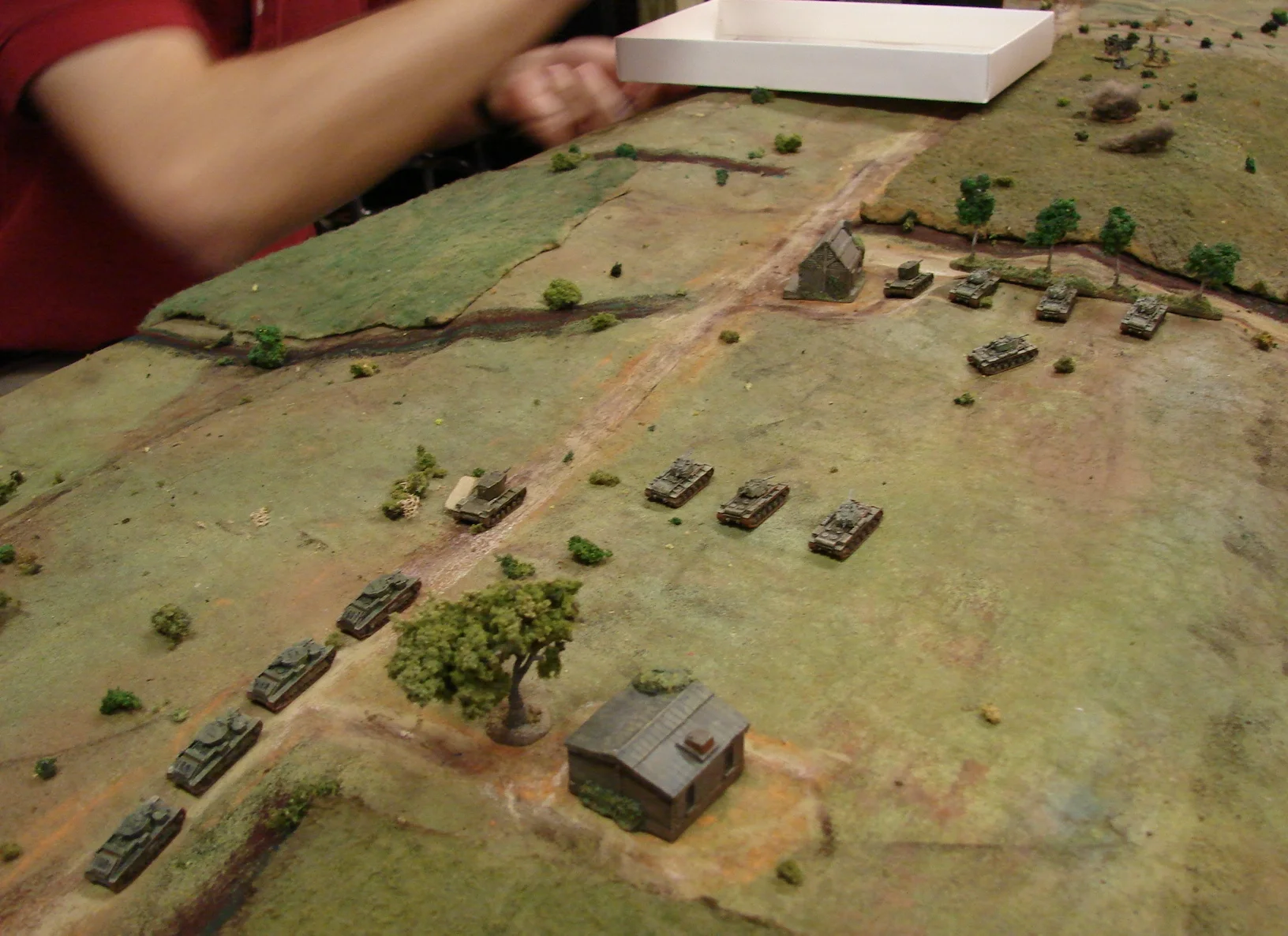 The heavy tanks are all here The Soviets managed to get seven KV-1s all the way to the centre of the table without running one into a ditch. One of the KV-2s however did breakdown. Meanwhile Doug is running the T-28s of the 2nd Battalion precariously tight up the road. It looks like Brian's redeployed guns have lost the race as the line of KV-1s is plastering the German guns directly in front of them.