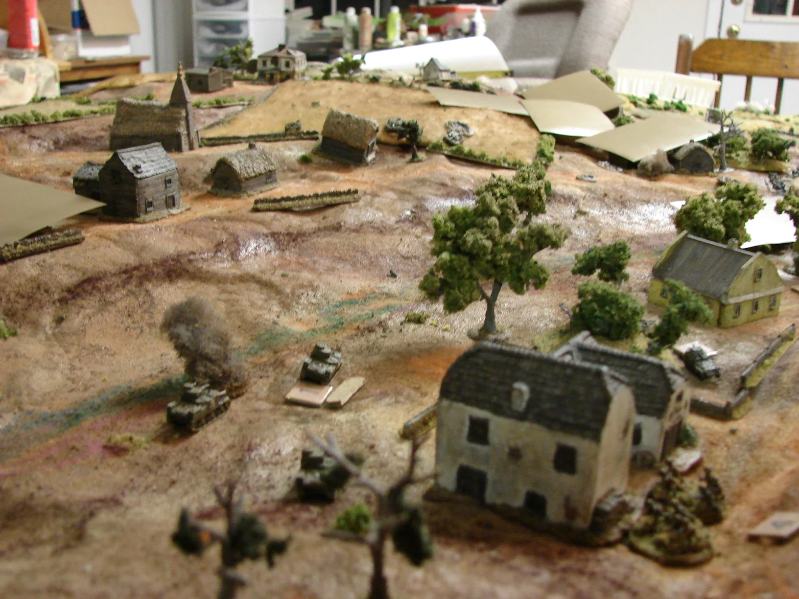 Grants in trouble As the infantry huddles in the farm buildings, the Grants come under fire from across the stream. One M3 is KO'ed quickly and two others take hits.