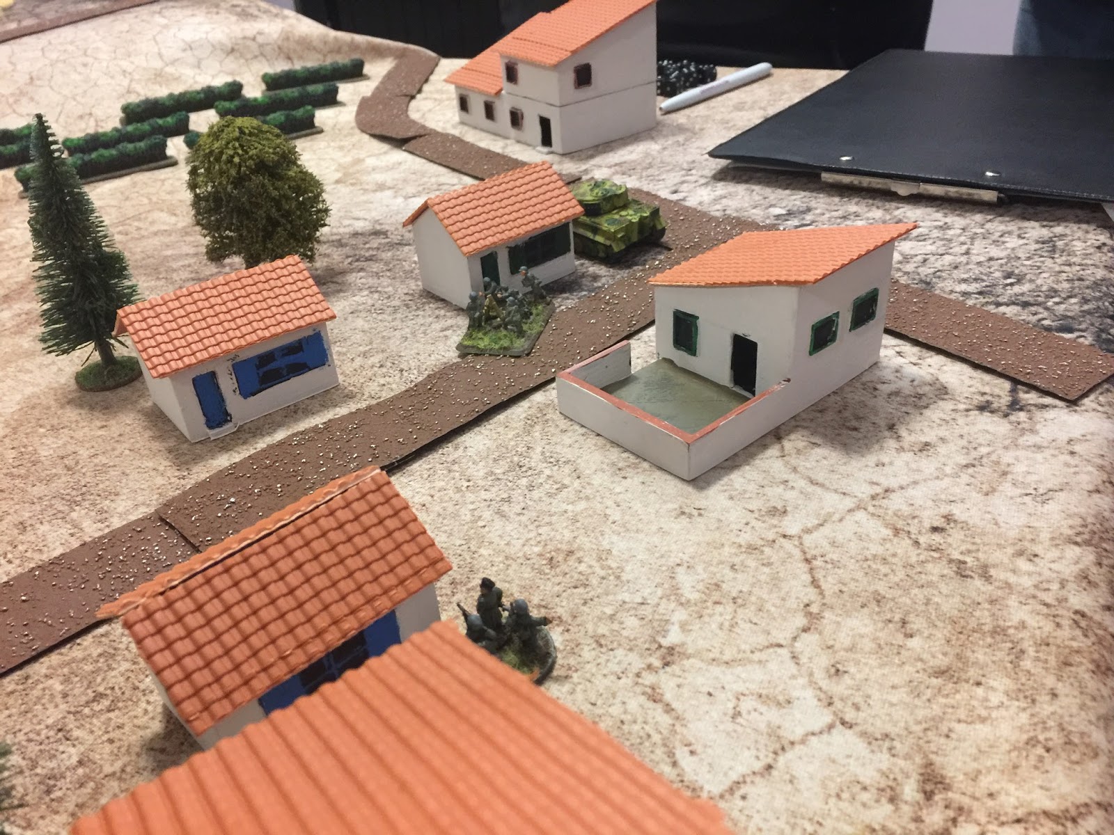 The 'Tiger' lurking behind a house. (The roof material is Wills 00 pantile sheet). Also visible one of the German MG teams and the overall German CO. And some Battlefront vineyards, with a heavy ink wash to hide the hideously bright green! 