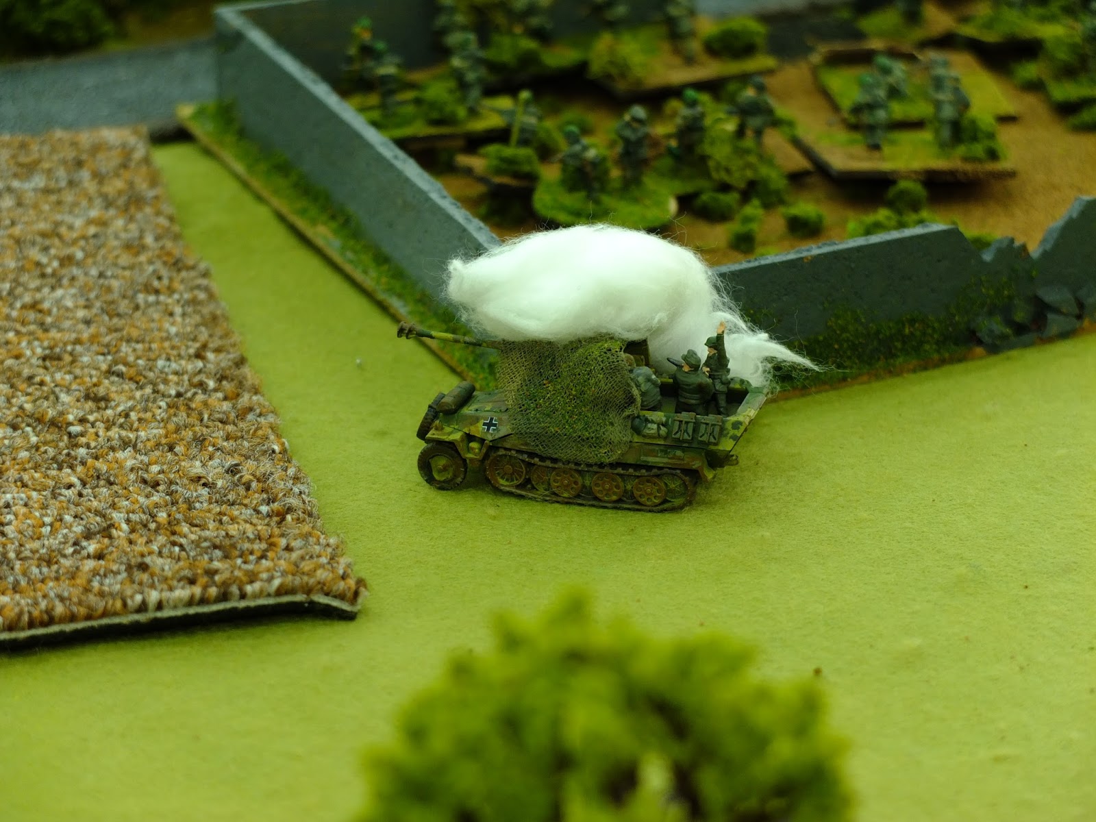 Bazooka fire destroys the half track