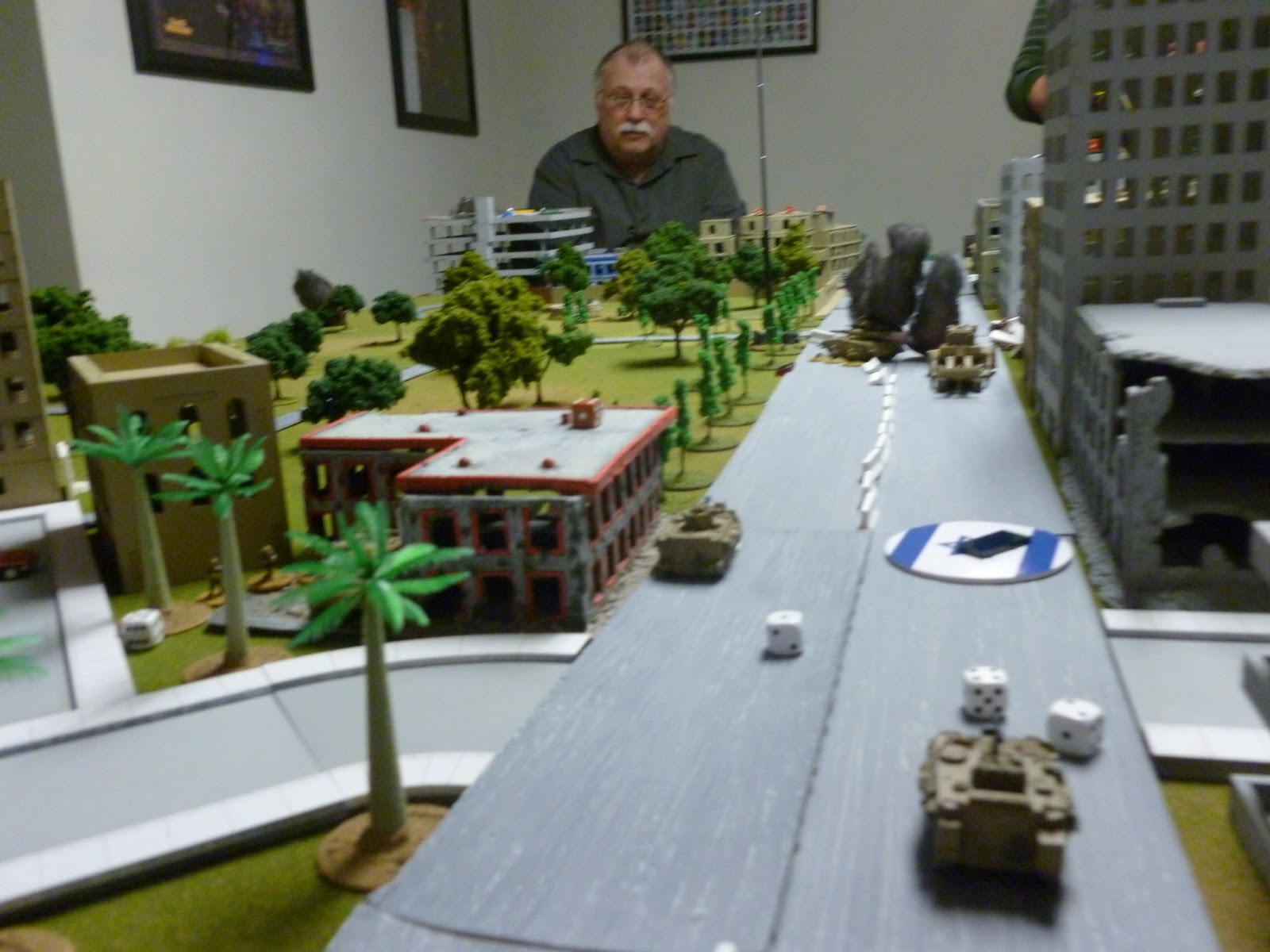  Old Sarge contemplating the mayhem from the PLO end of the table.&nbsp;  A couple more RPG hits and the 'dozer will surely block the opening it just made in the barricade. 
