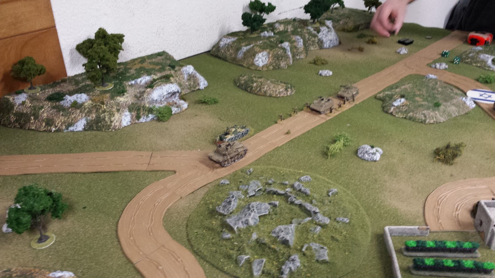 The Magach has its eyes on the prize, but the advance is slow as they round the walled orchard.