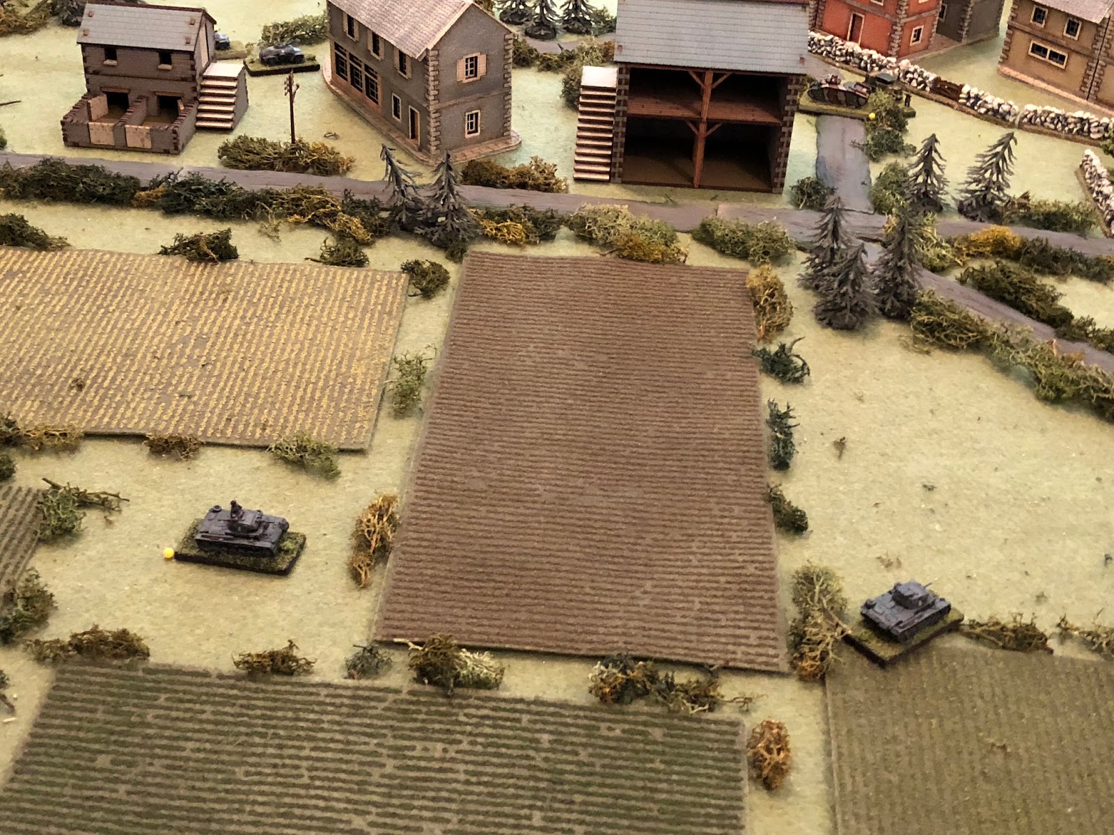  Sgt Mayer thinks he's going to get on the flank but his tank bottoms out in a rut in the field (bottom right), significantly slowing it down, while Lt Loeb's driver (left) appears to be having problems manipulating the transmission, as they don't mo