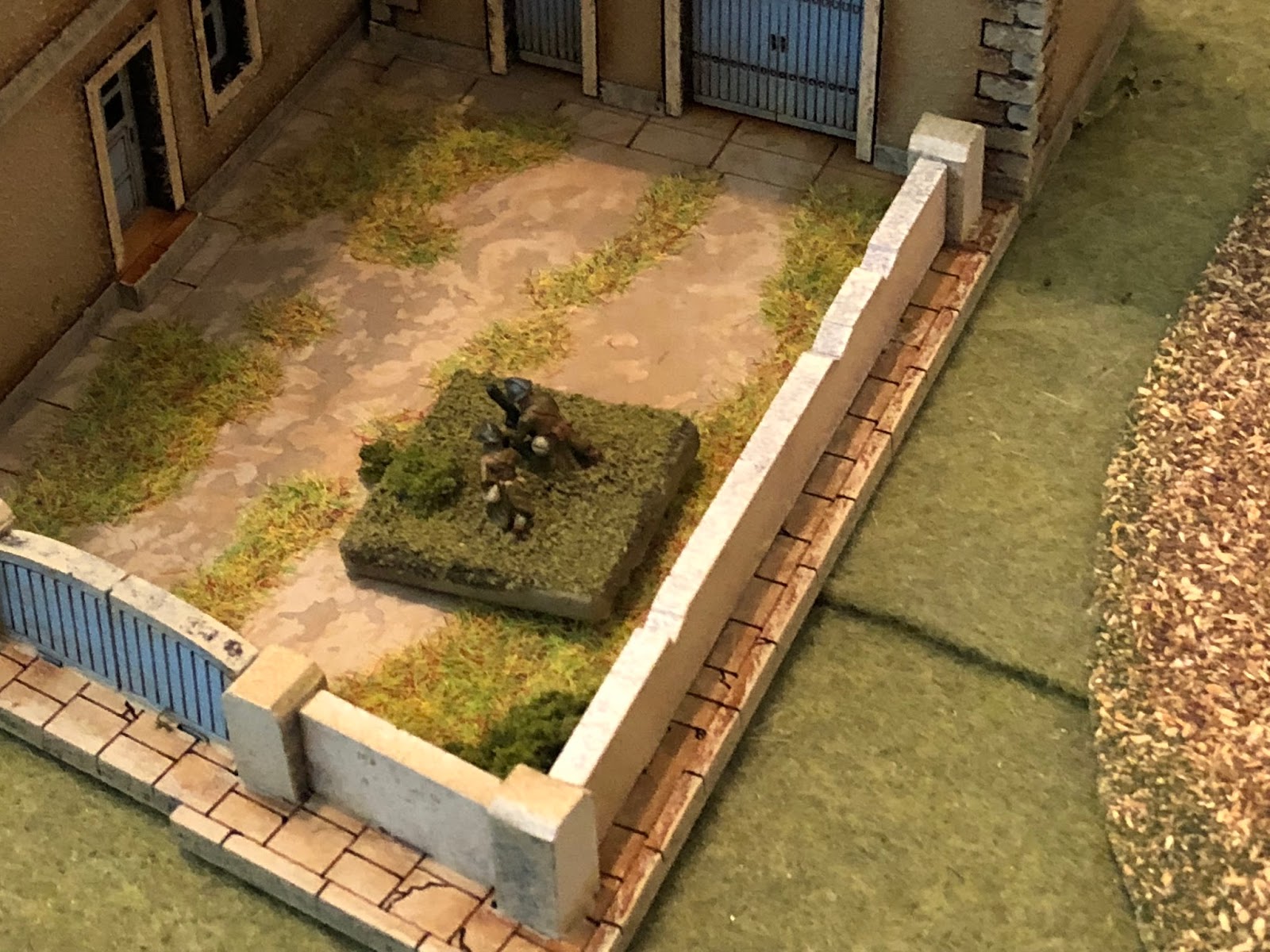  Below in the courtyard, the French 81mm mortar fires a spotting round at the German ATGs, which is off target... 
