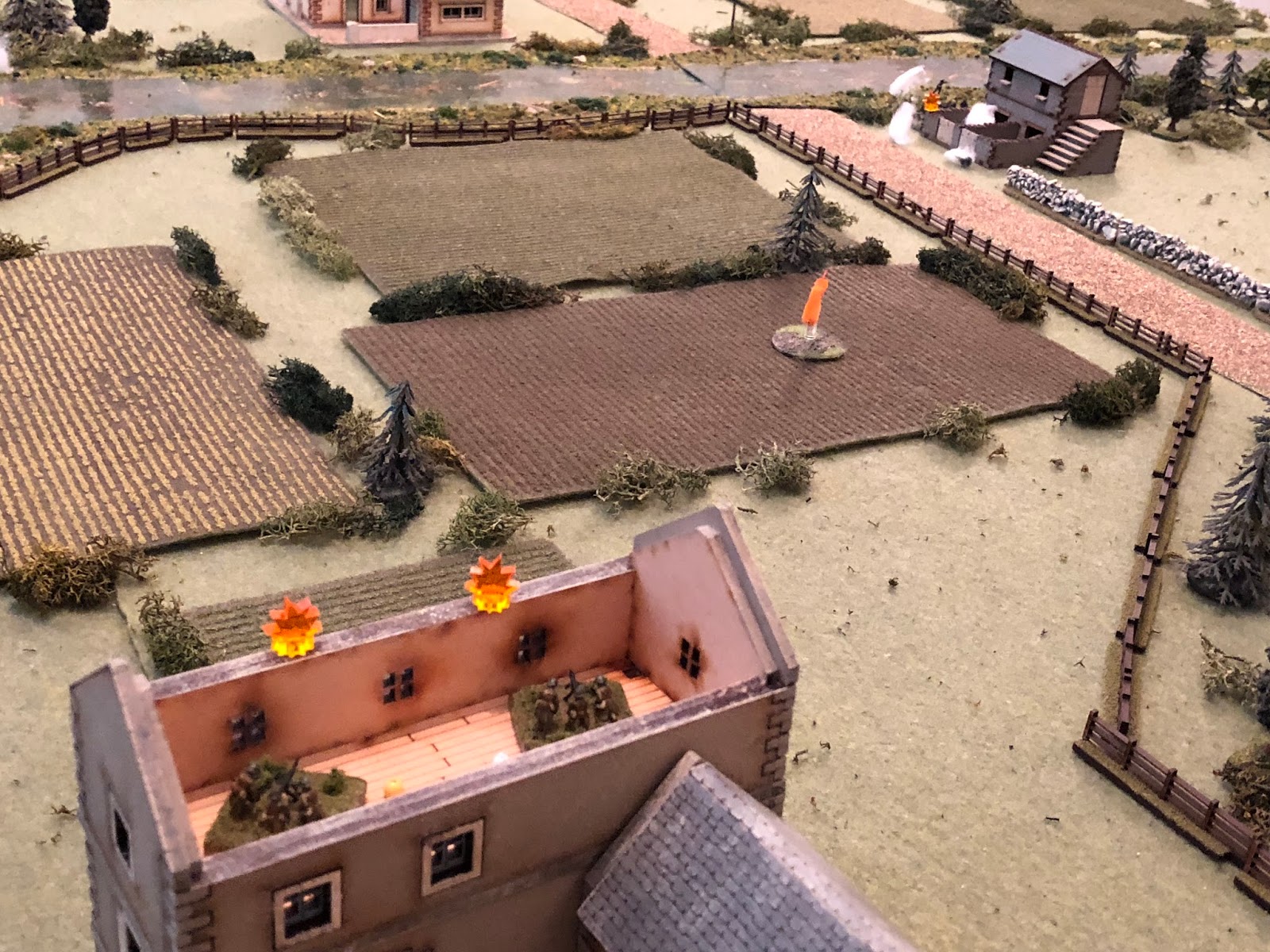  With one of the MG teams still suppressed (bottom center), the other French MG team (bottom left) turns on the tollkeeper's house (top right) and cuts loose on the two German engineer squads, but they're safely hunkered down in cover. 