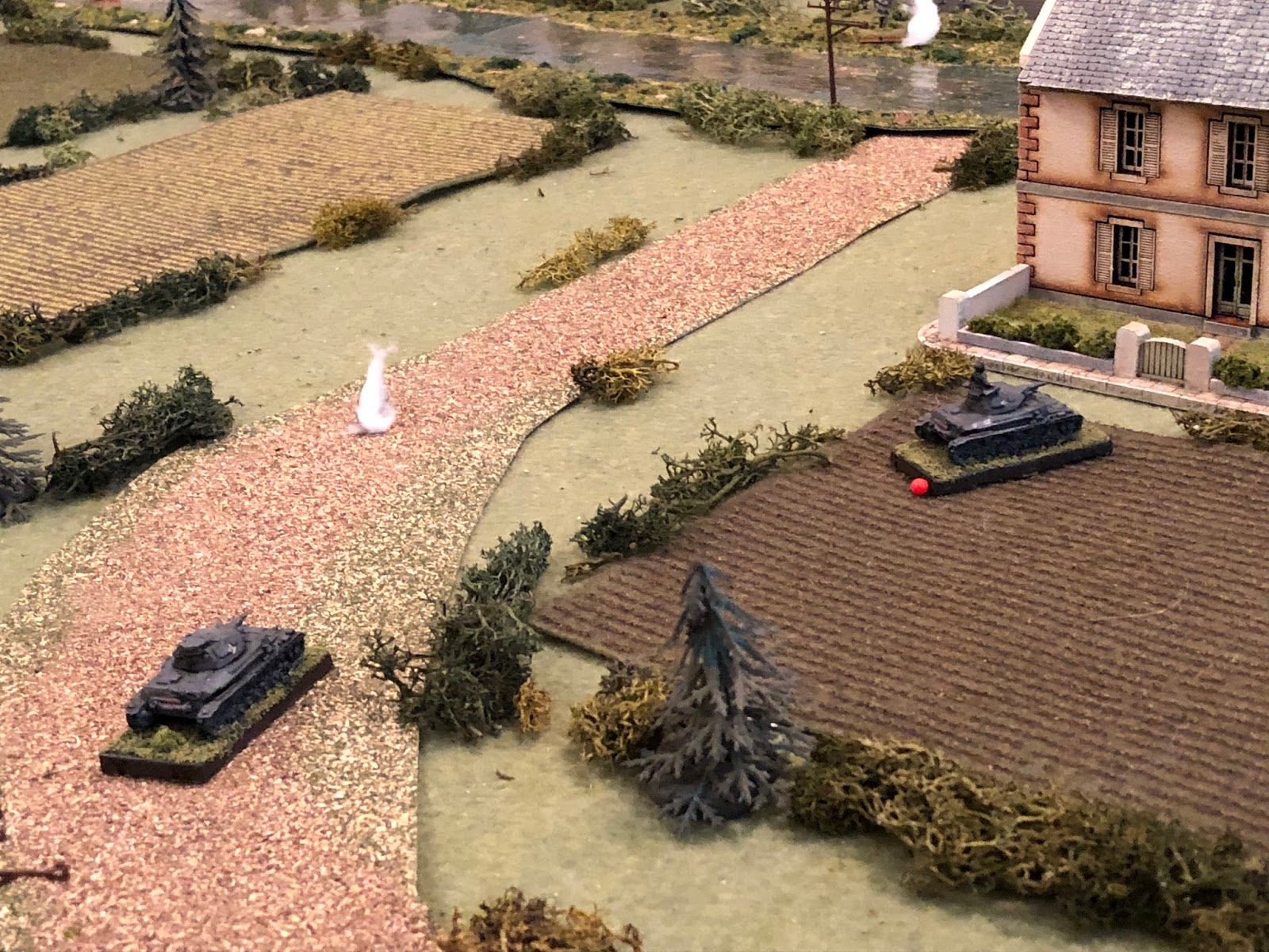  Which is enough to force Sgt Graebner's Pz IV off the road and into shelter behind Mlle Chevelle's house (red bead at right, from white puff at left, with Sgt Kapp's Pz IV at bottom left). 