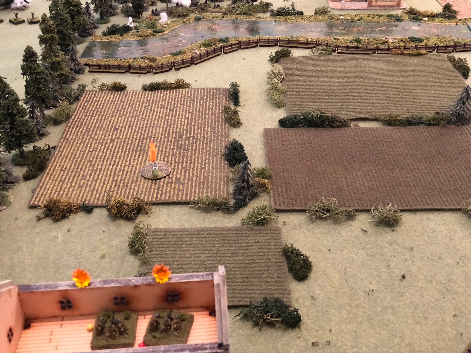  In the north, on the 2nd floor of the farmer's residence (bottom left), one MG team is still suppressed, but the other team, which is only pinned, gets back in the fight, spraying rounds into the northern treeline (top center left)... 