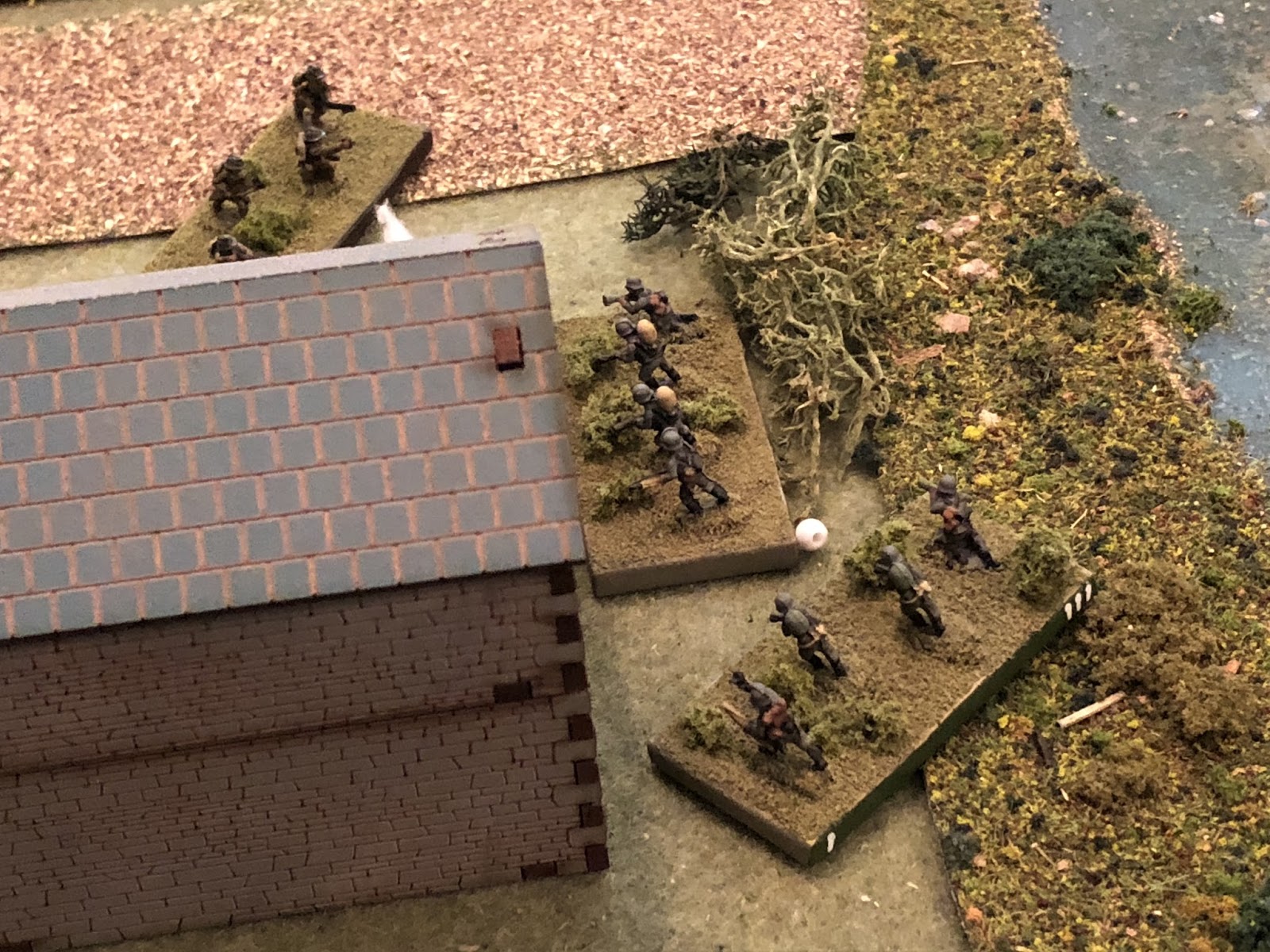  Back at the tollkeeeper's house, Sgt Hafl's engineer squad (white bead) has suffered casualties and is suppressed.&nbsp; Sgt Barkstrom's squad (bottom center) can't see anything, but they can hear tank firing (off camera to top left) and have a stra