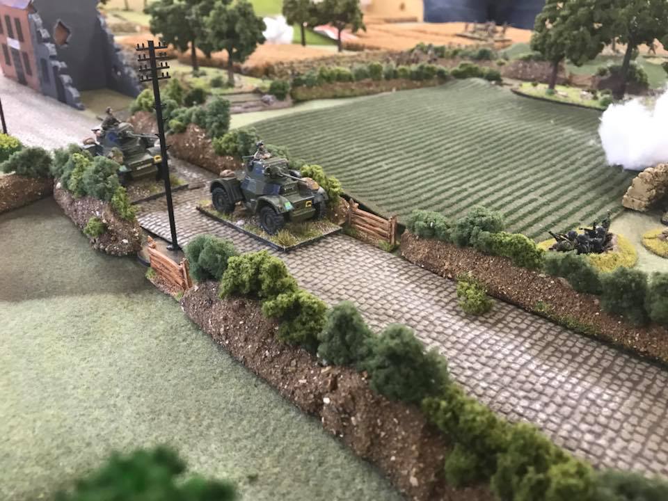 The recce troop roars down the road to outflank the central German force.