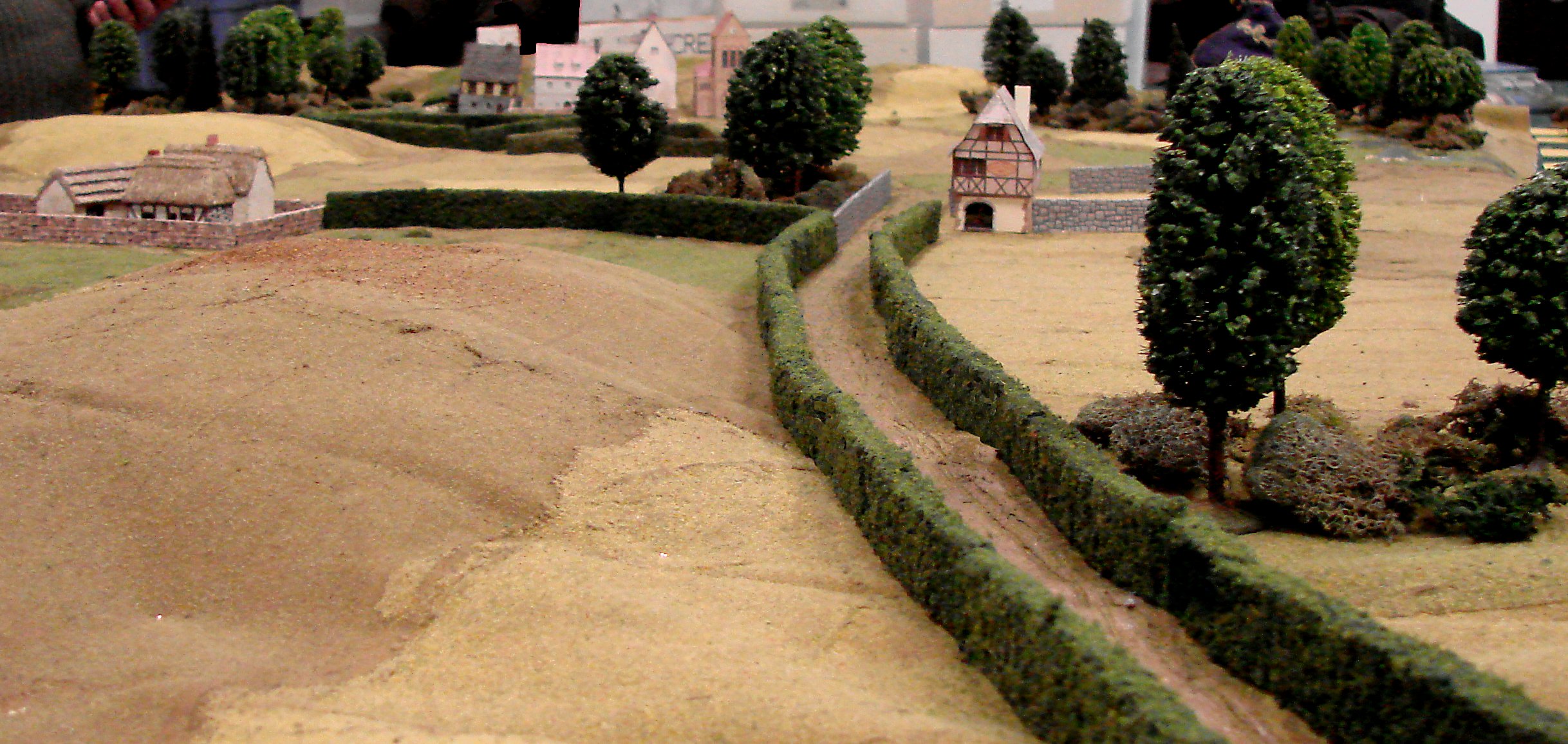 One of the lines of German approach; a covered lane that leads to a walled farm and a chateau.