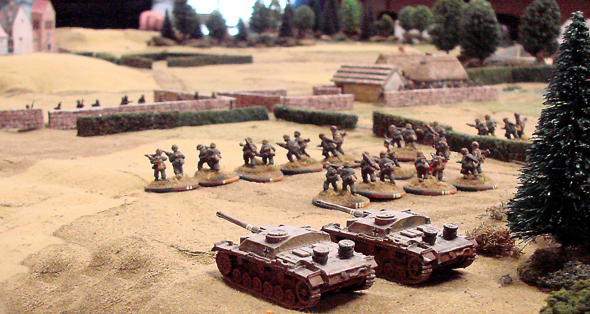 On the left flank, an advancing platoon is supported by a couple SturmGeschutzen.