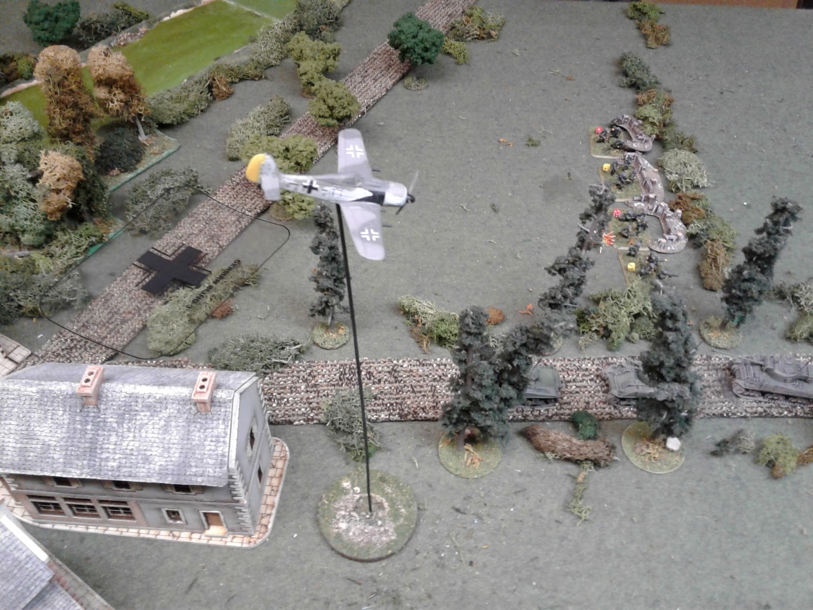 A FW 190 strafes the road, stopping the allied advance.