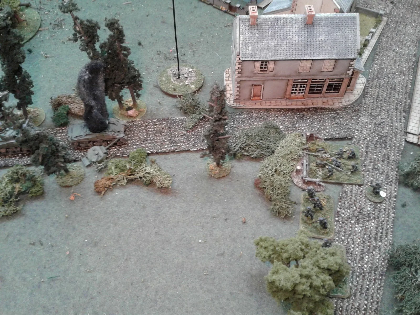 A PaK 40 reveals itself, brewing up the lead Sherman. 