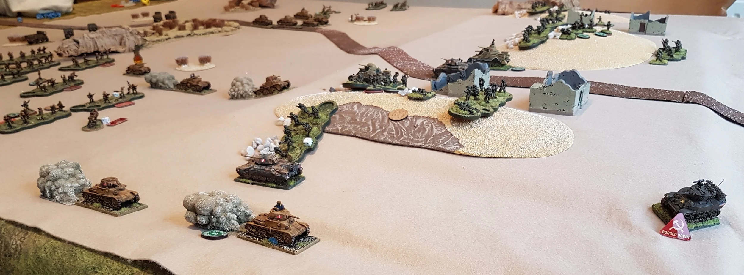 Two Italian tanks burst through the line. Note the Bogged Down Honey!