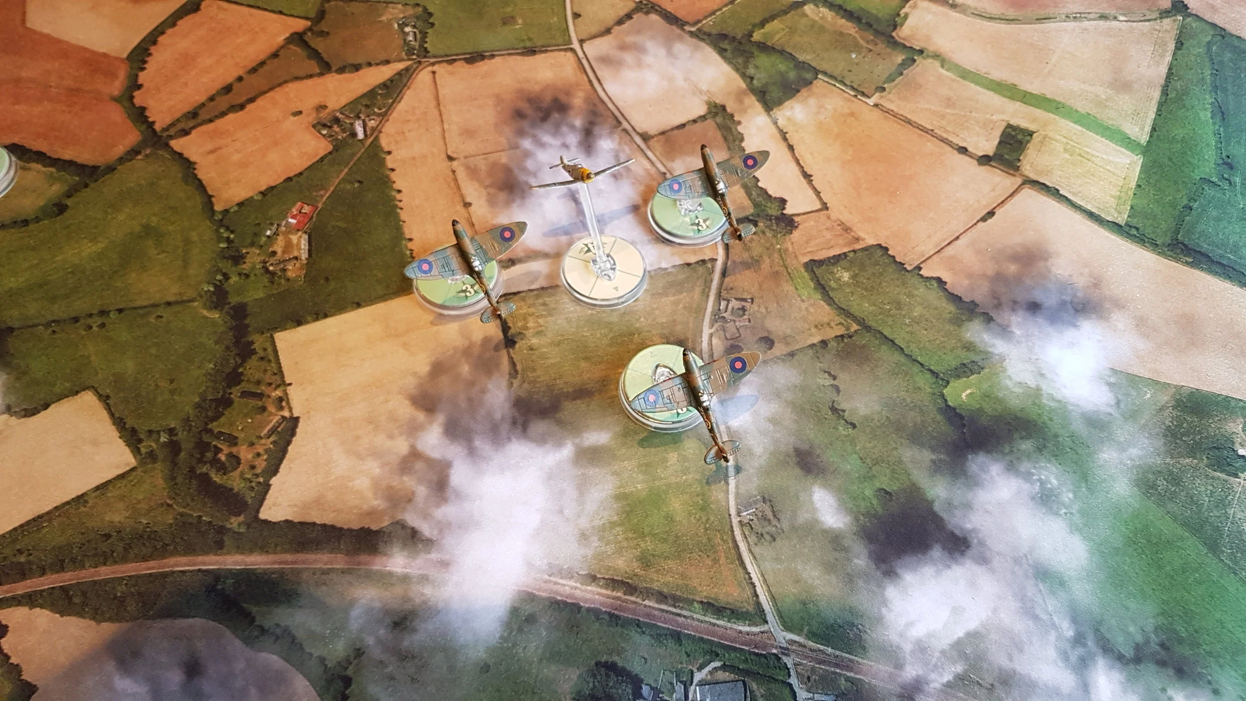 A 109 climbs towards a flight of Spitfires