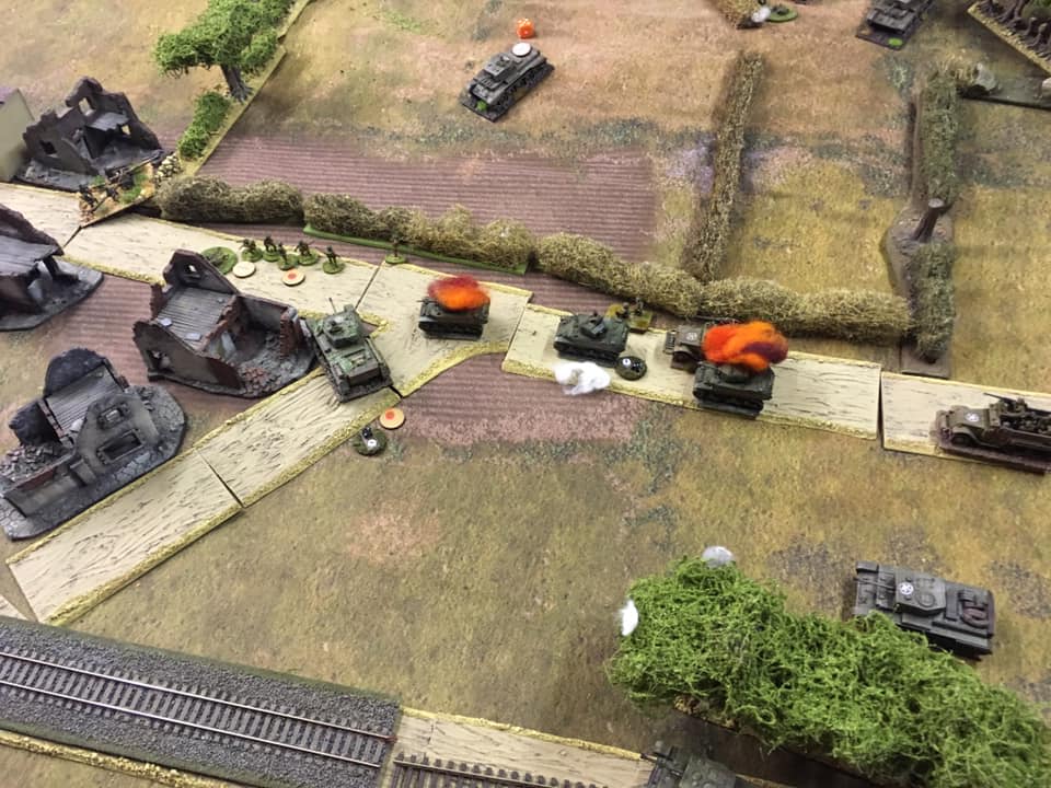 The remains of the reconnaissance platoon are bypassed by the Guards infantry whilst Cromwell tanks home in on their targets
