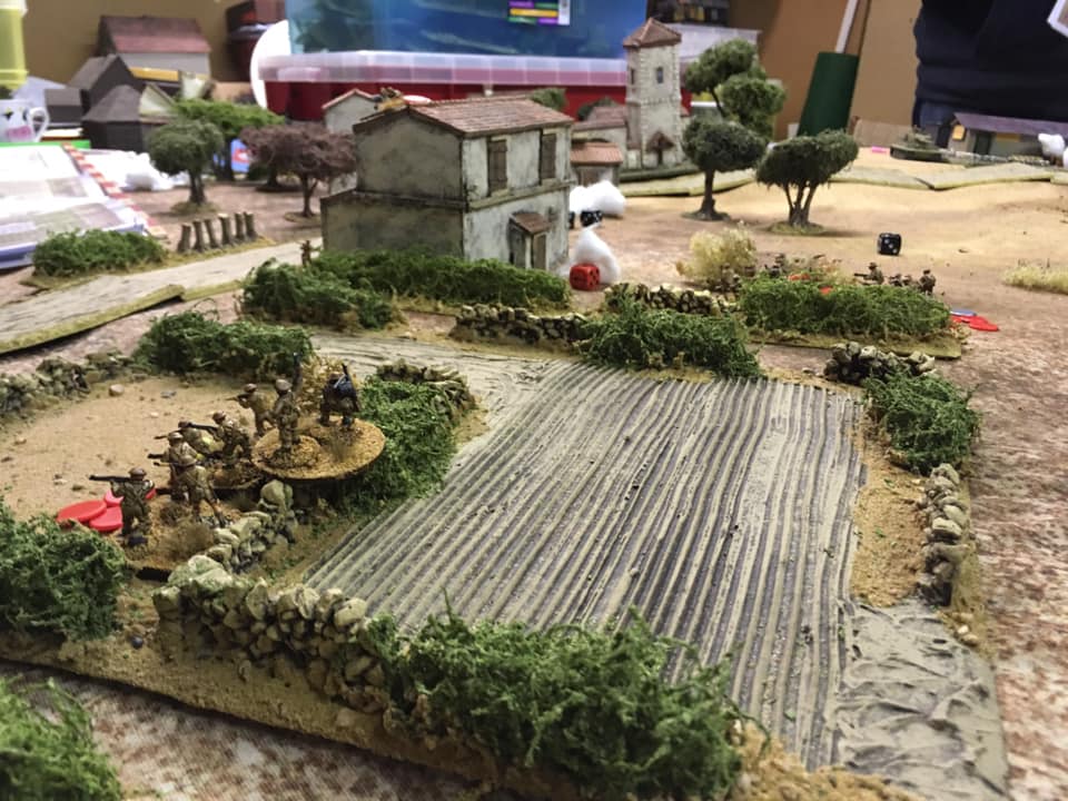  British infantry moving through the vineyards next to the Villa . 