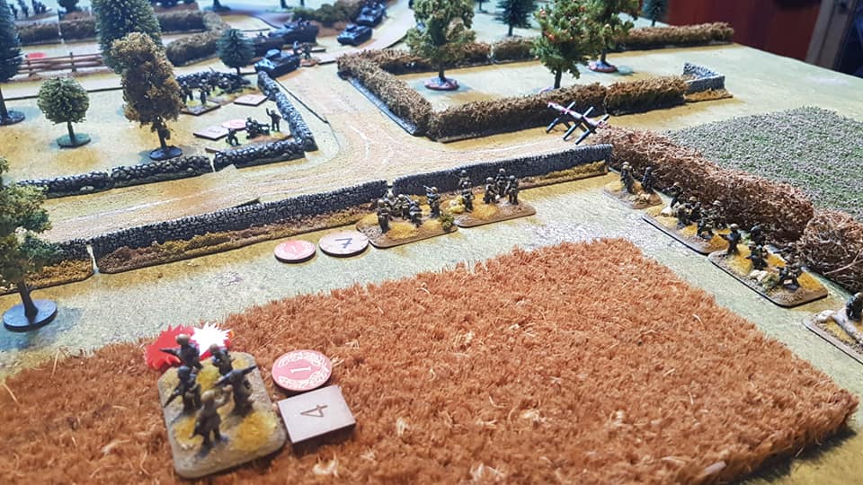  Each German squad advances on the left flank but the forward squad is ambushed by a British section in the farm and the second squad is held up by and a Vickers firing from the corner (top). Any moment, that German squad, top, is about to be ambushe