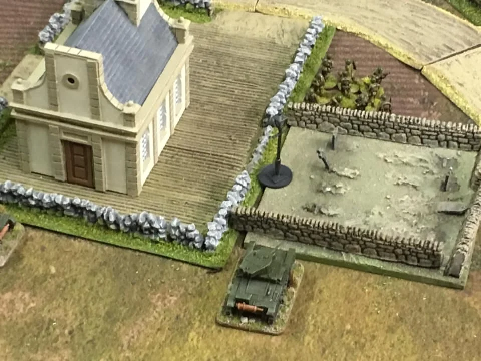 A view of the church and the cemetery with the adjacent objective number one. The Soviet T-26 tank is engaged in a firefight with the Polish infantry section to the top of the picture. They remained a thorn in the side for a significant period until defeated by weight of firepower from supporting Soviet armoured fighting vehicles .