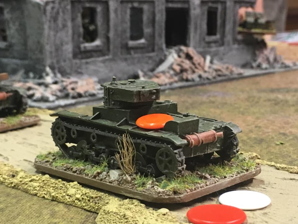 T26 struck by a Polish AT gun firing from the far corner of the building. Shock red, loss of one action dice white, buttoned down orange marker. This vehicle certainly went through the Mill tonight.