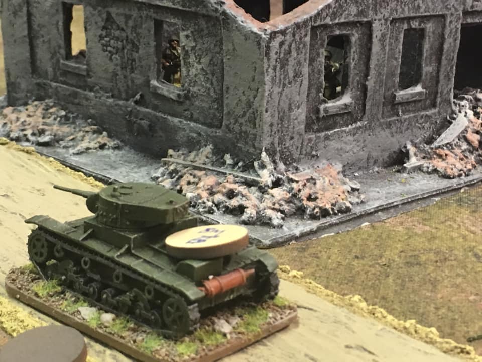 Tank platoon leader’s vehicle attempting to pass the fortified house and making a dash for the main objective beyond.