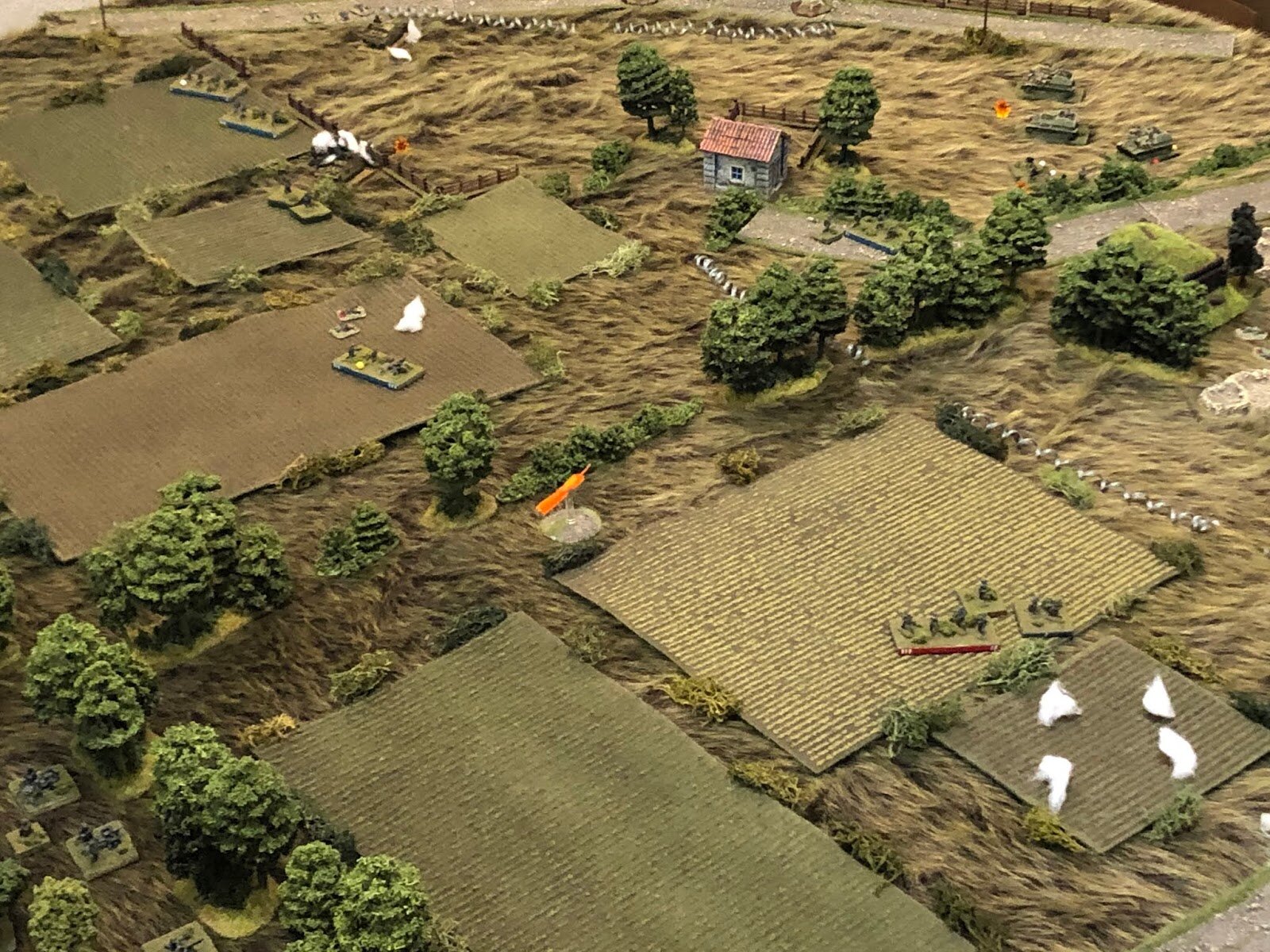 The German IG Platoon (bottom left) begins firing on the Soviet Su-76s (top right), forcing the Red 3rd Squad to dismount their vehicle and fall back, suppressed.